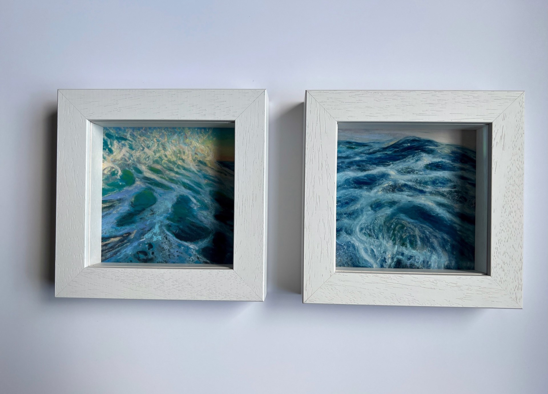 A painting of a wave crashing on the beach at sunset.