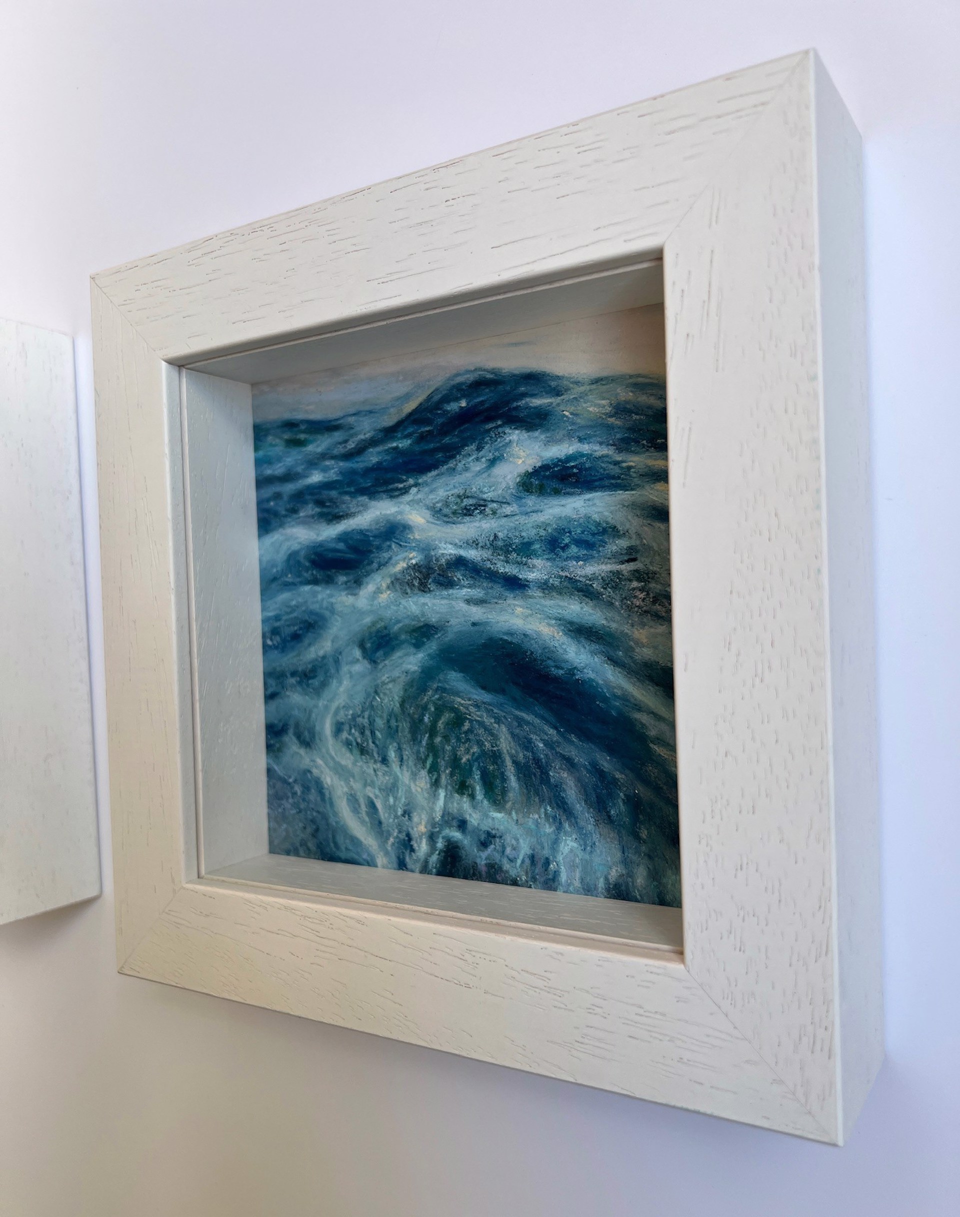 A painting of a large body of water with waves crashing on the shore.