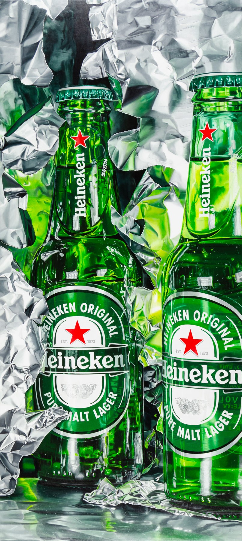 Two bottles of Heineken beer sitting on top of tin foil.