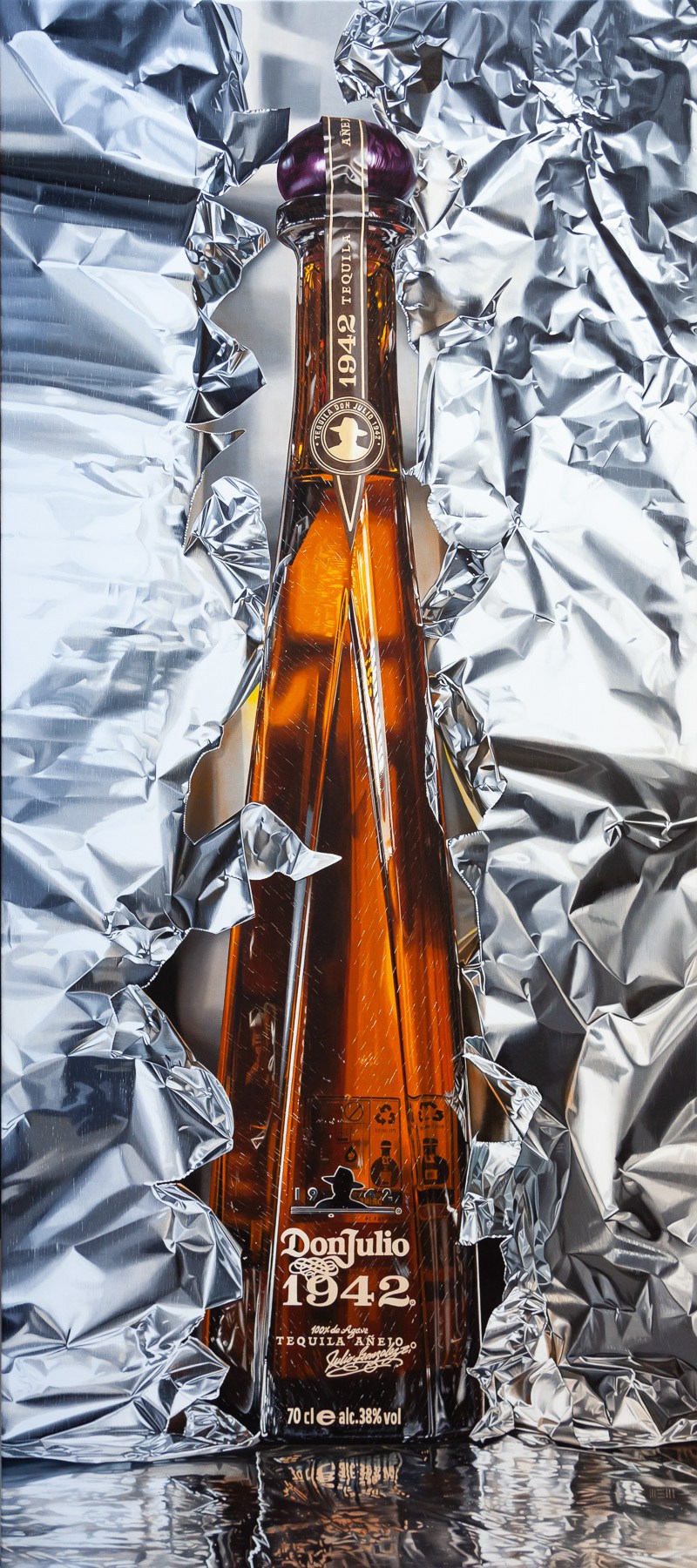 A bottle of liquor sitting on top of tin foil.