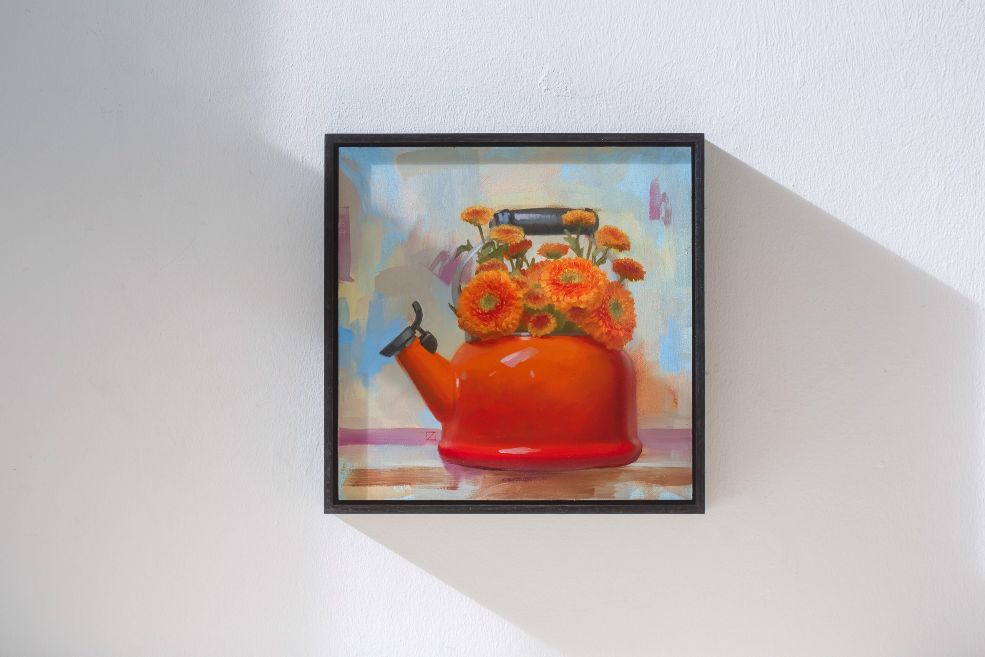 A painting of a red teapot with orange flowers in it.