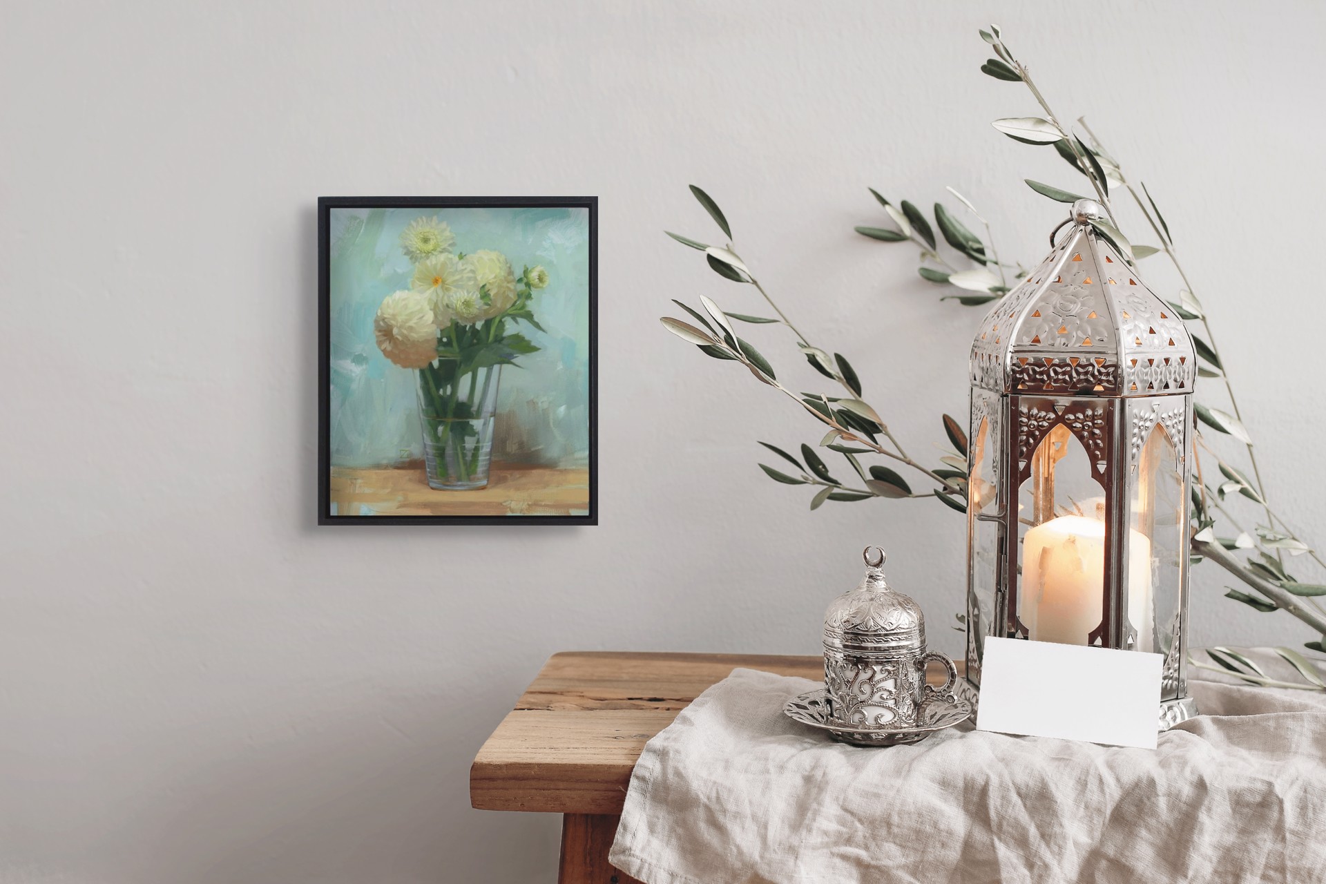 A still life painting of pale yellow flowers in a glass vase on a wooden surface.