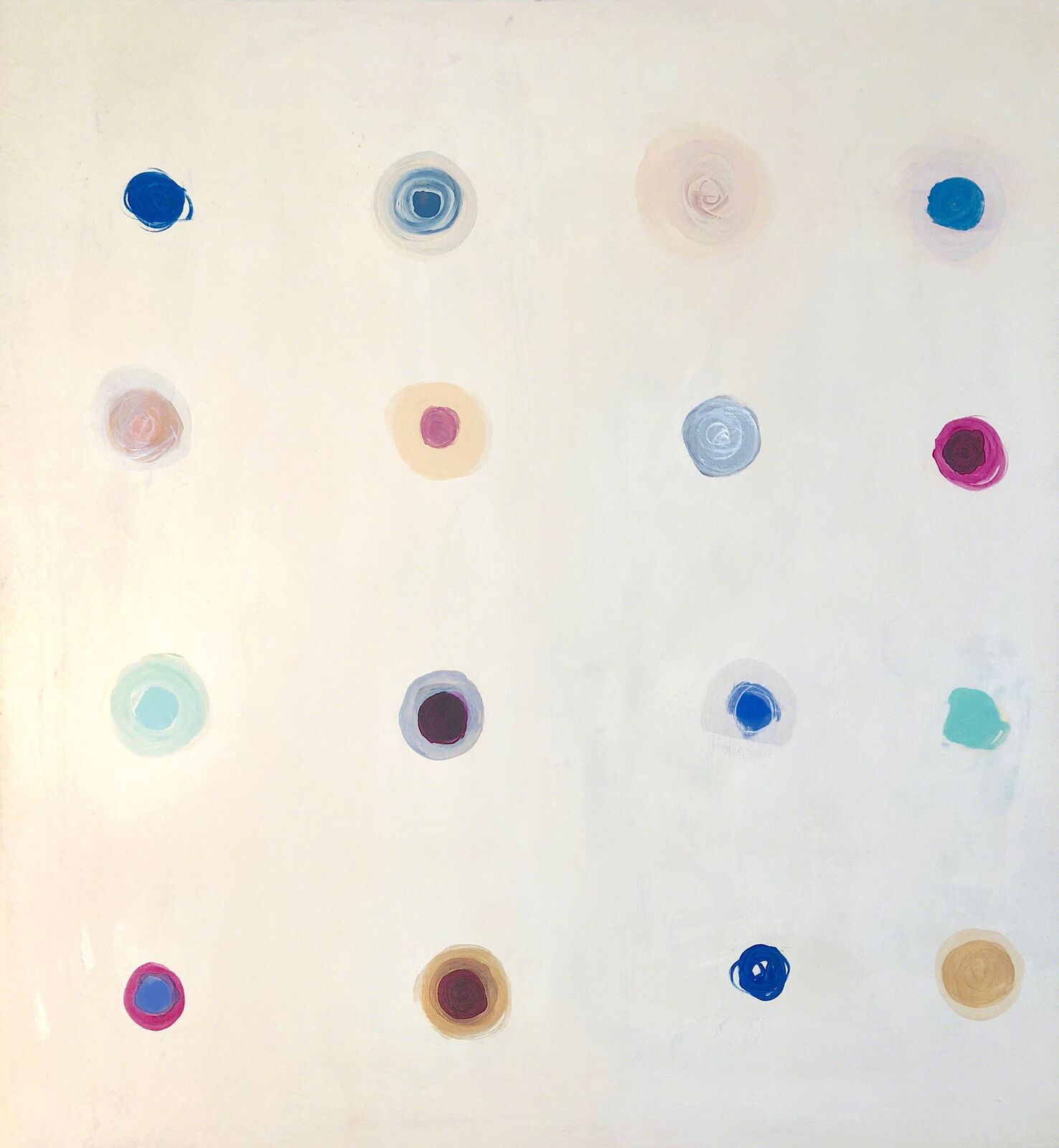 A minimalist composition of scattered, colorful circular marks on a pale background.