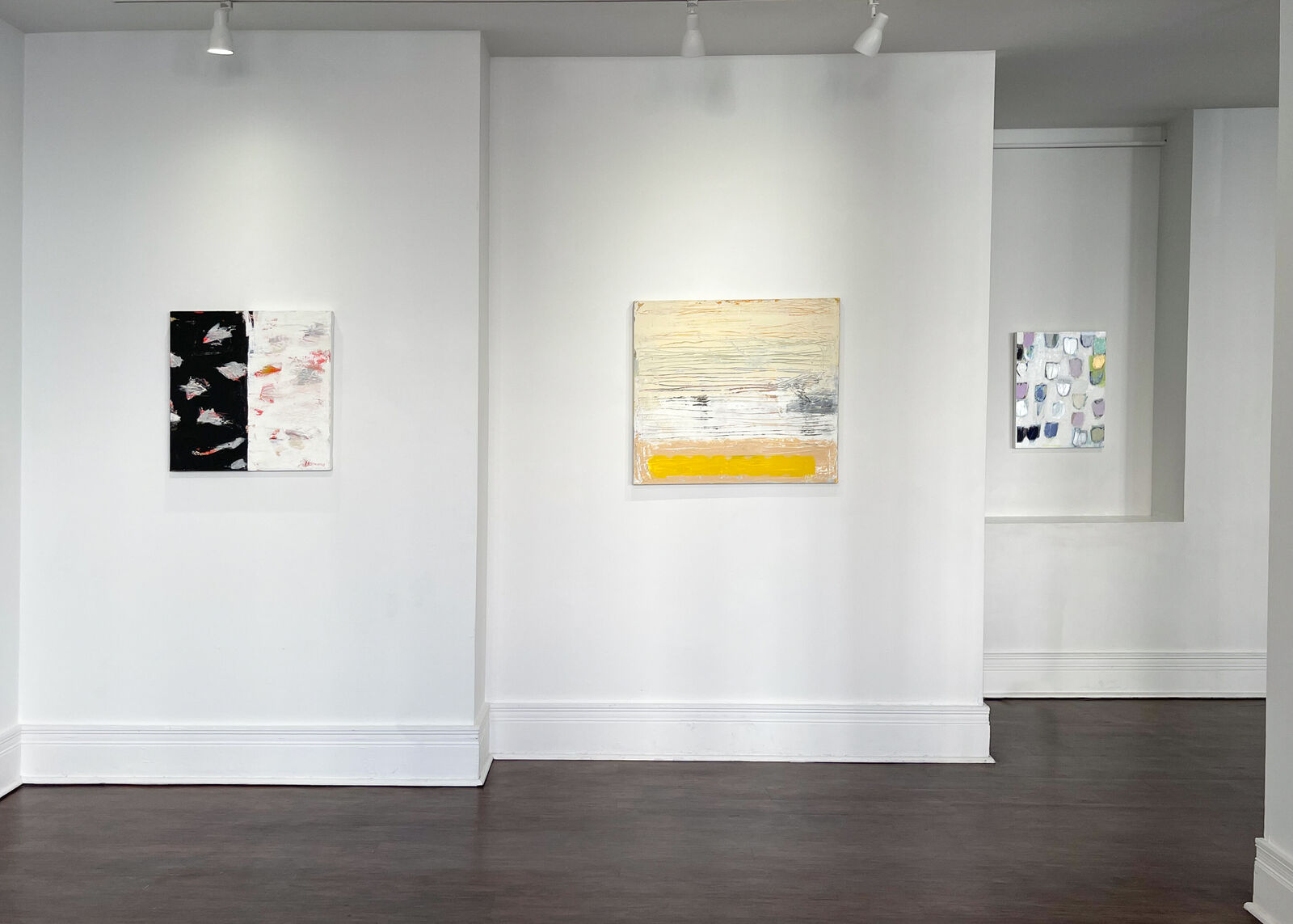 A stark abstract painting split by a vertical line, featuring bold black and white textures with splashes of red.