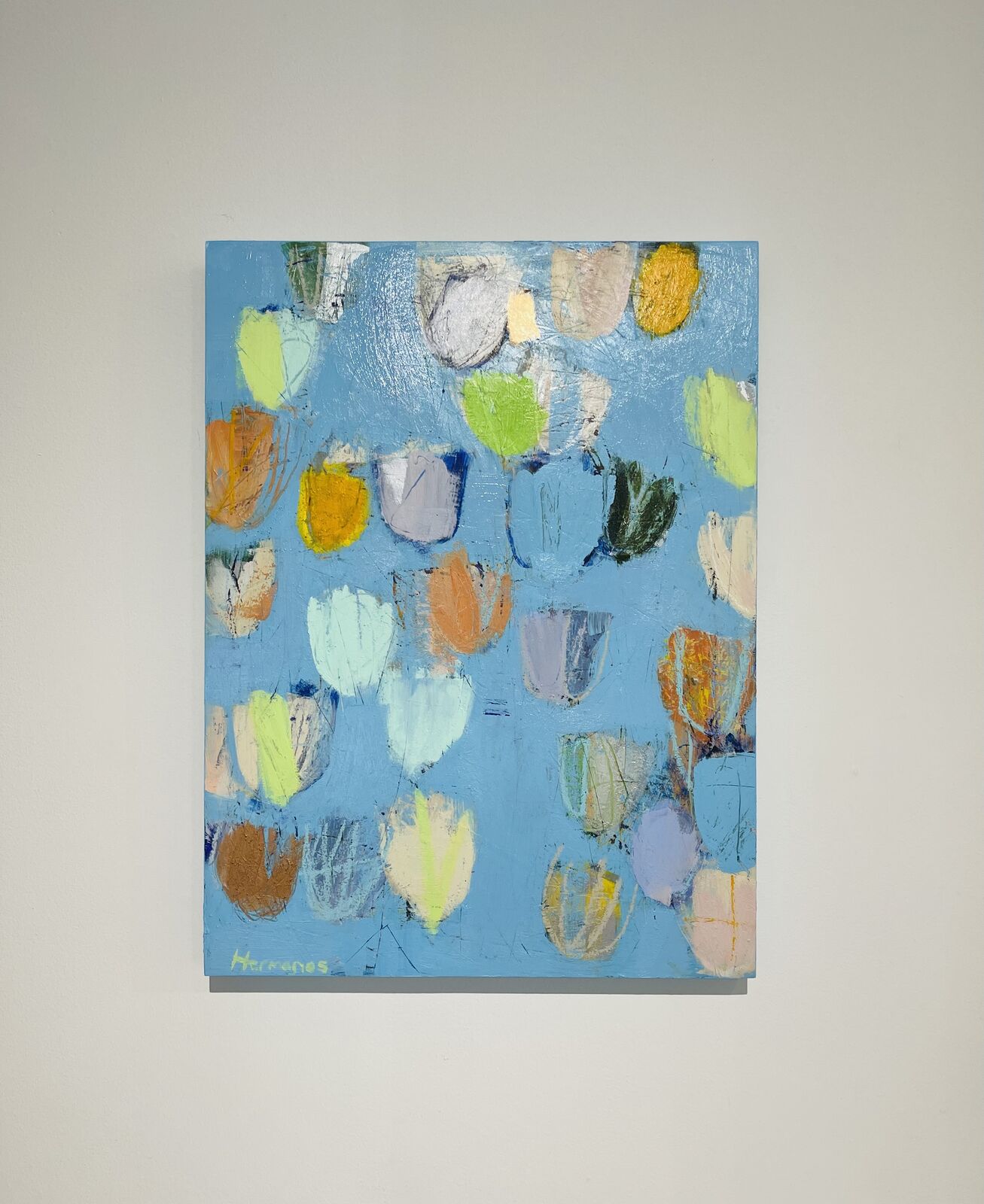 An abstract expressionist painting featuring a light blue background with scattered, colorful organic shapes.