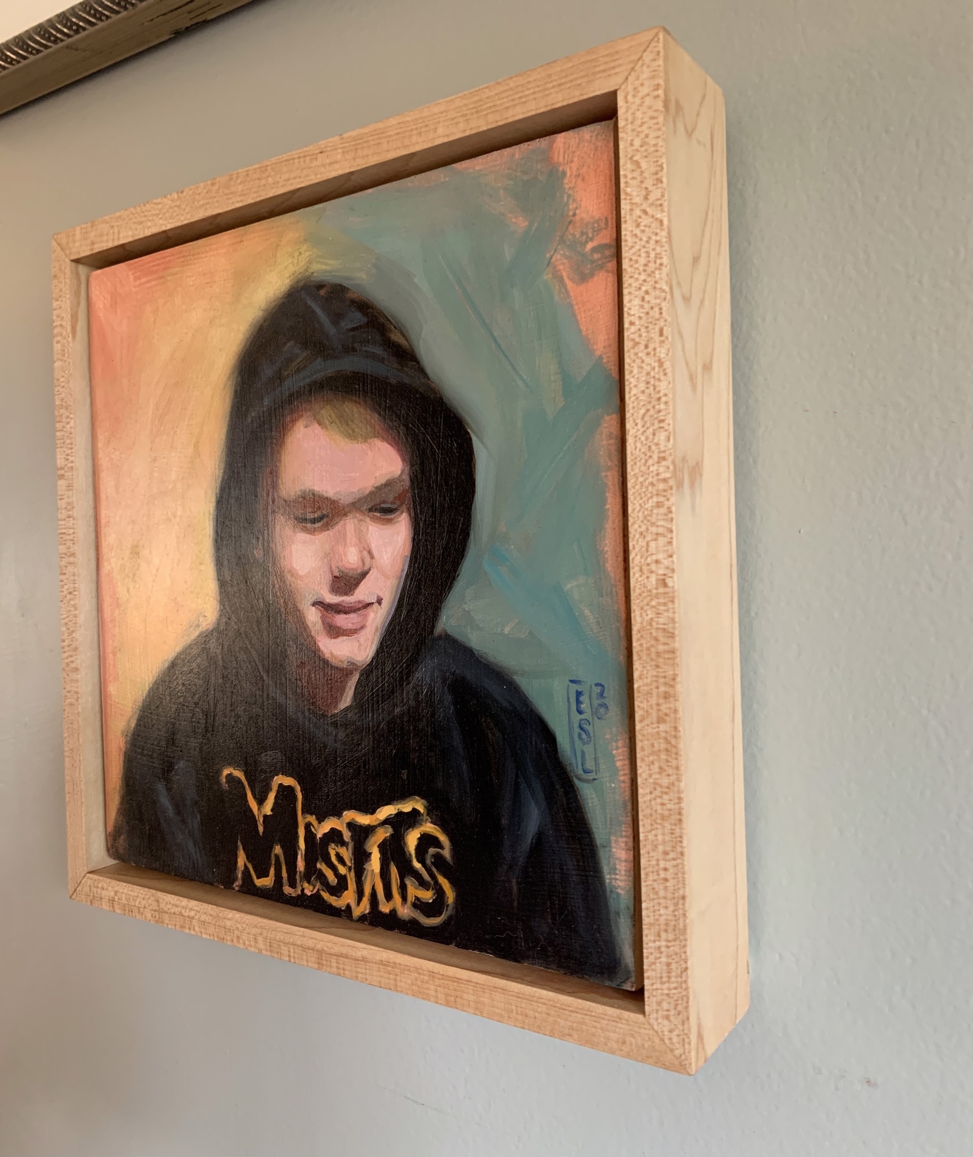 A painting of a young man wearing a black hoodie.