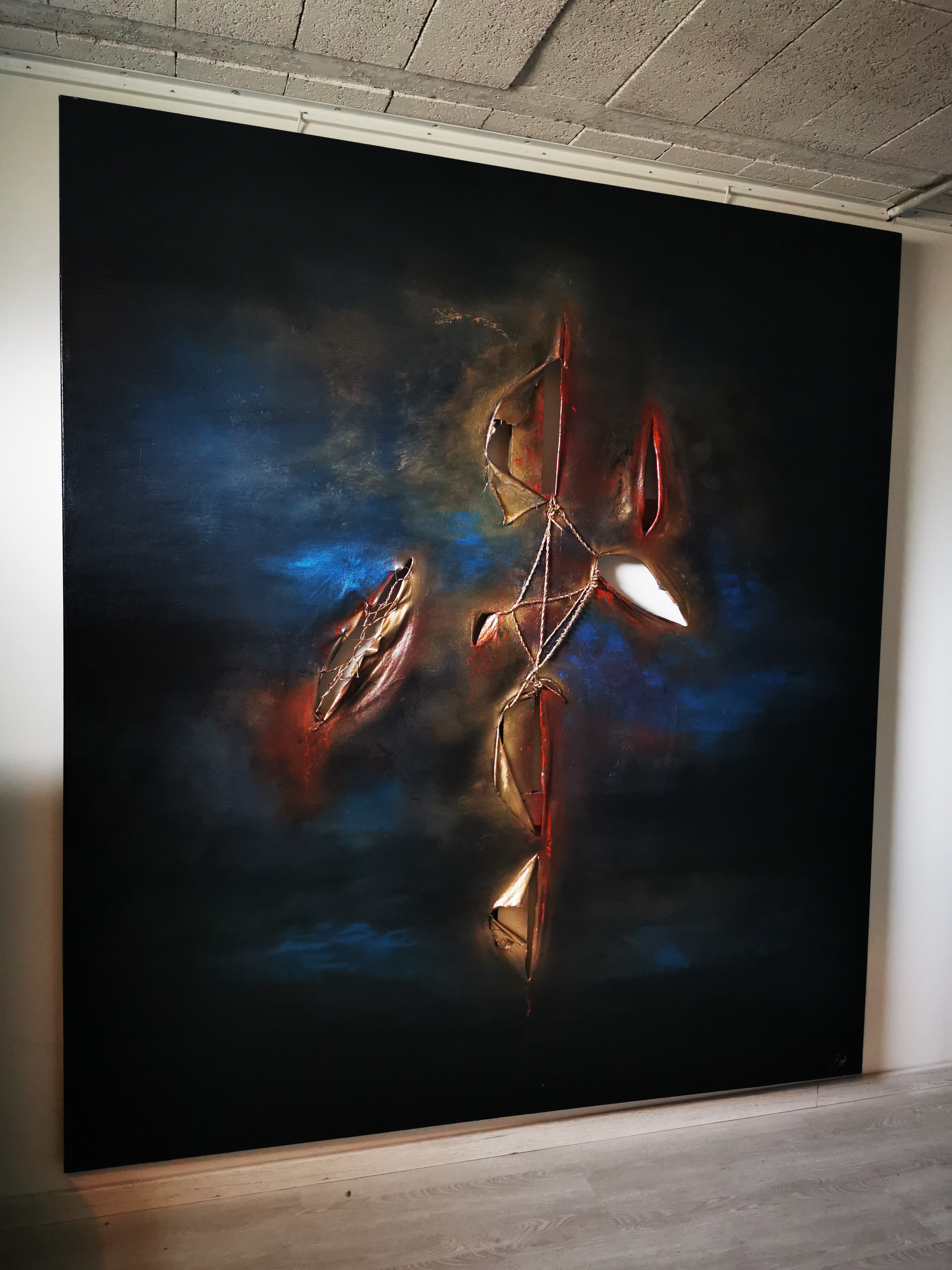 A large painting hanging on a wall in a room.