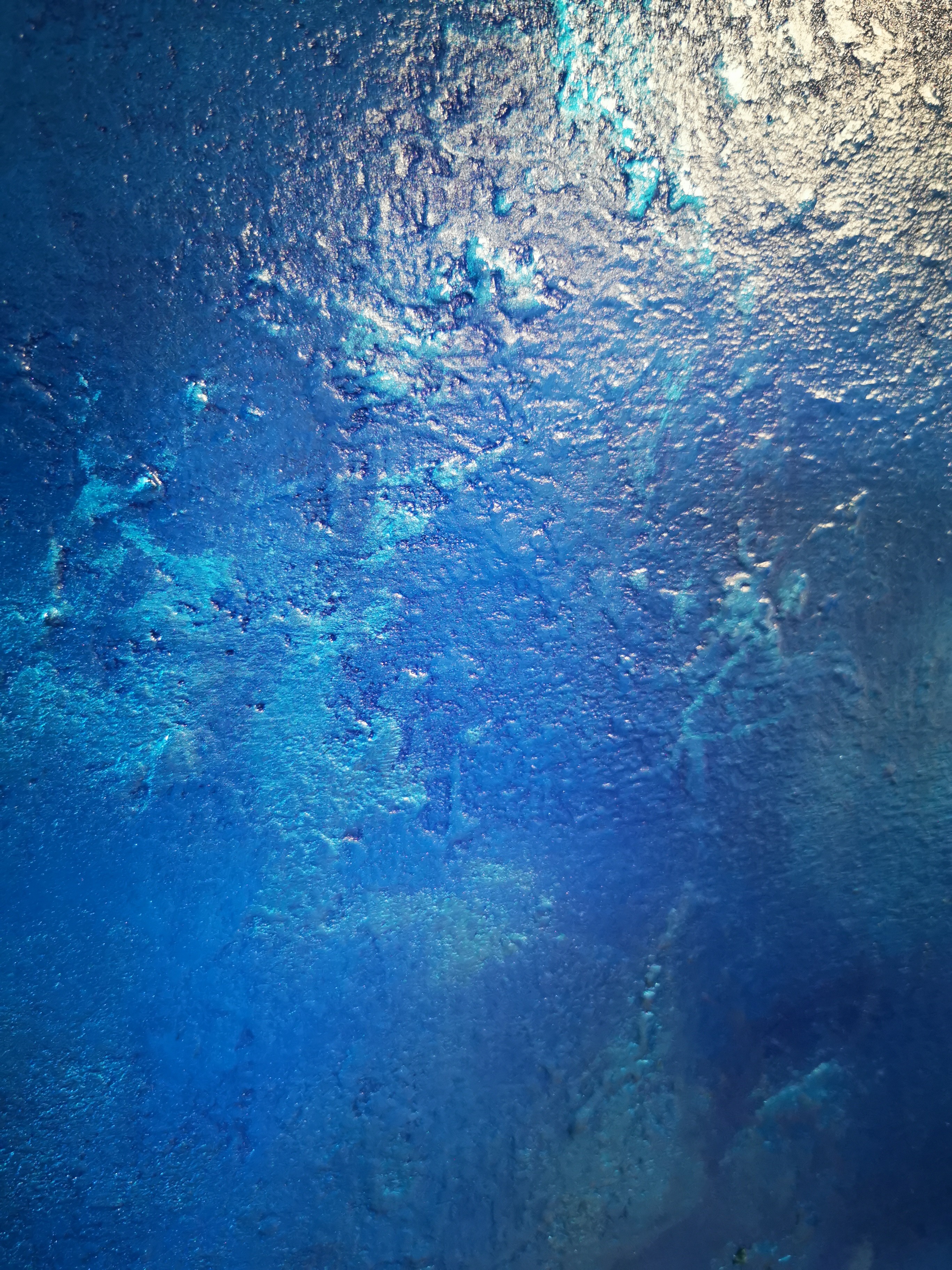 A large blue painting hanging on a wall.