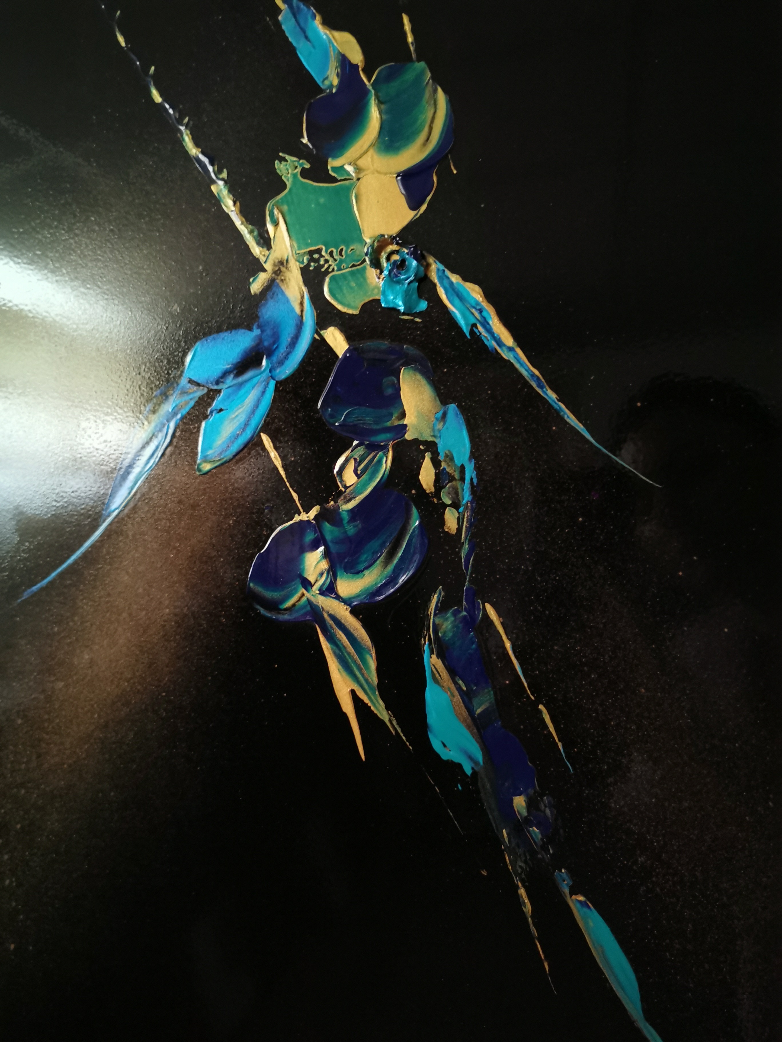 A painting of a blue and yellow insect on a black background.