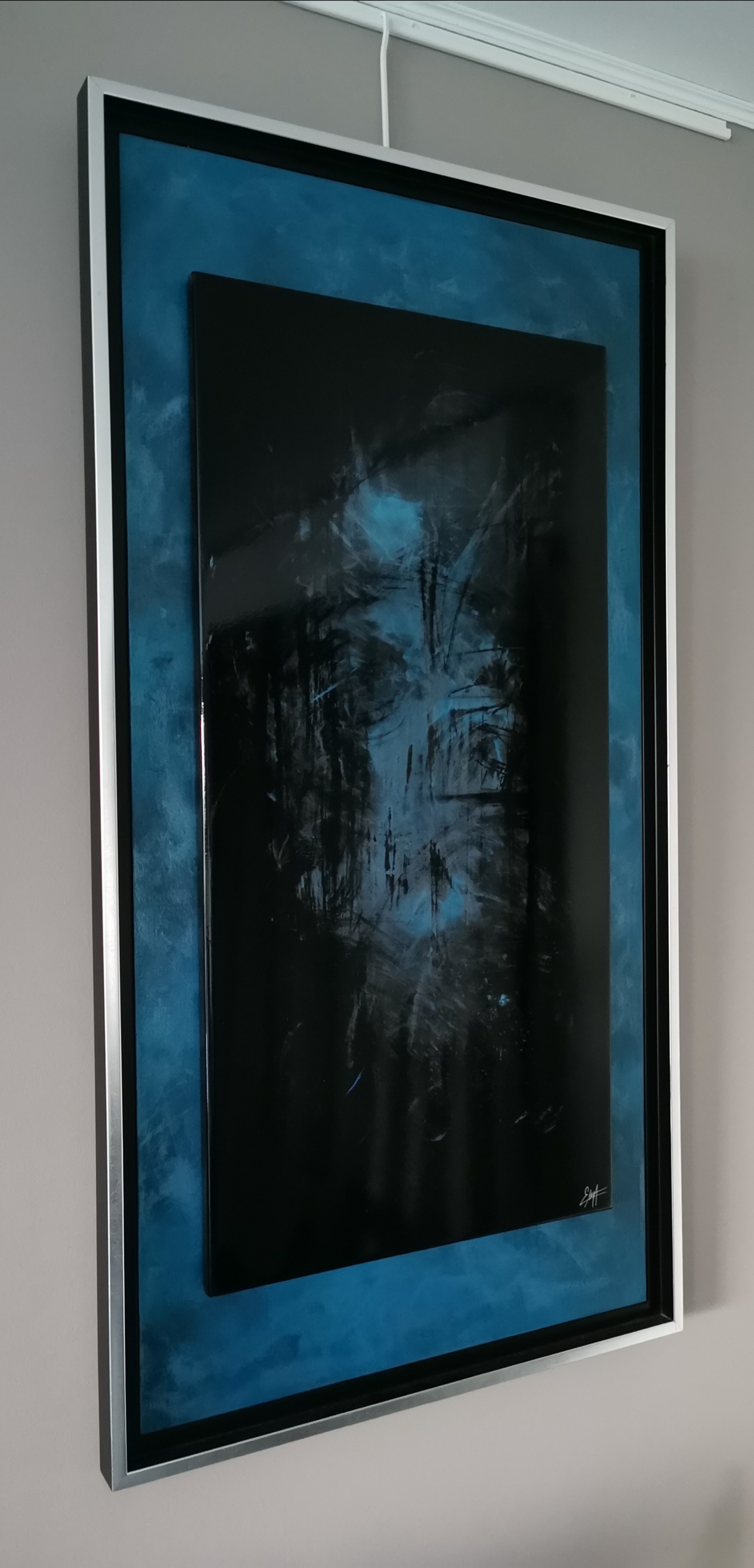 A painting hanging on a wall in a room.