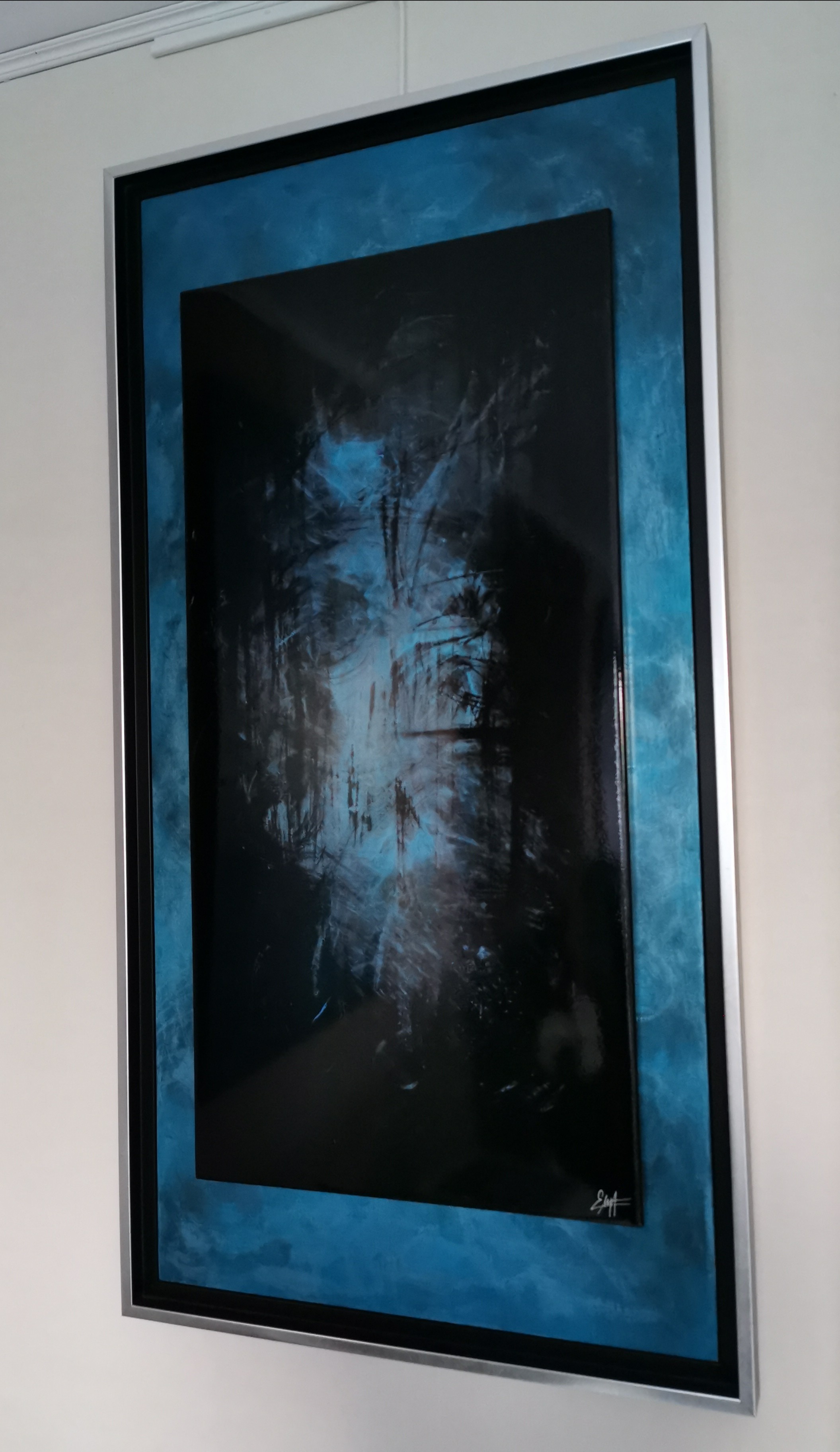 A painting hanging on a wall in a room.