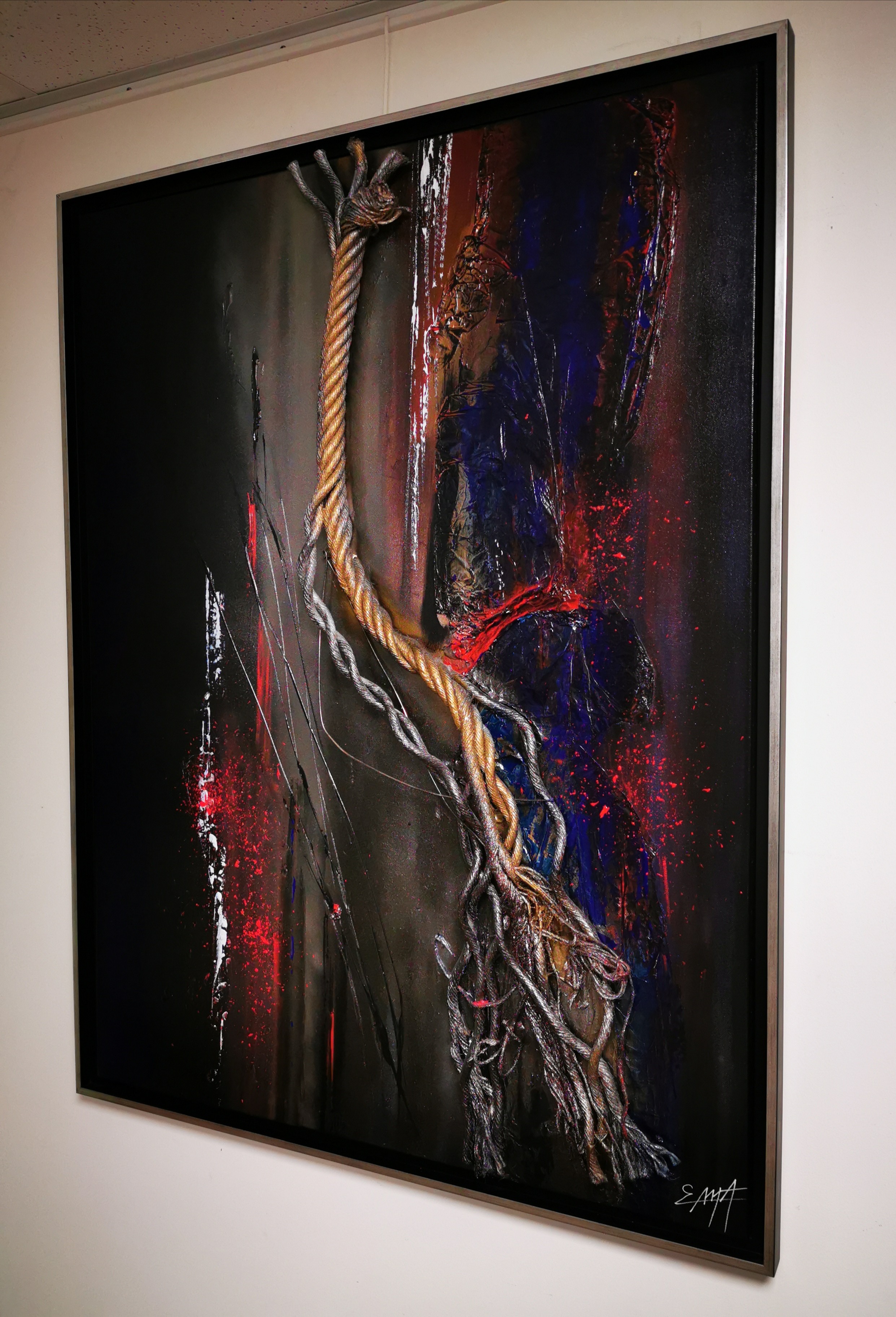 A painting hanging on a wall in a room.