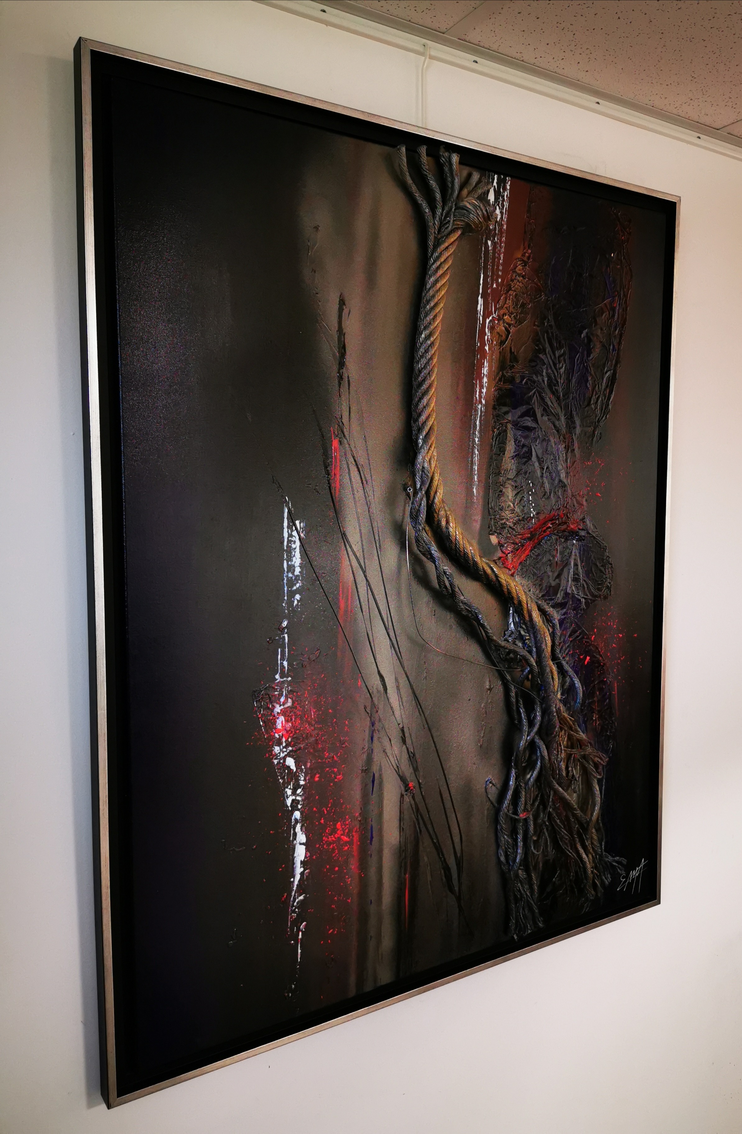 A painting hanging on a wall in a room.