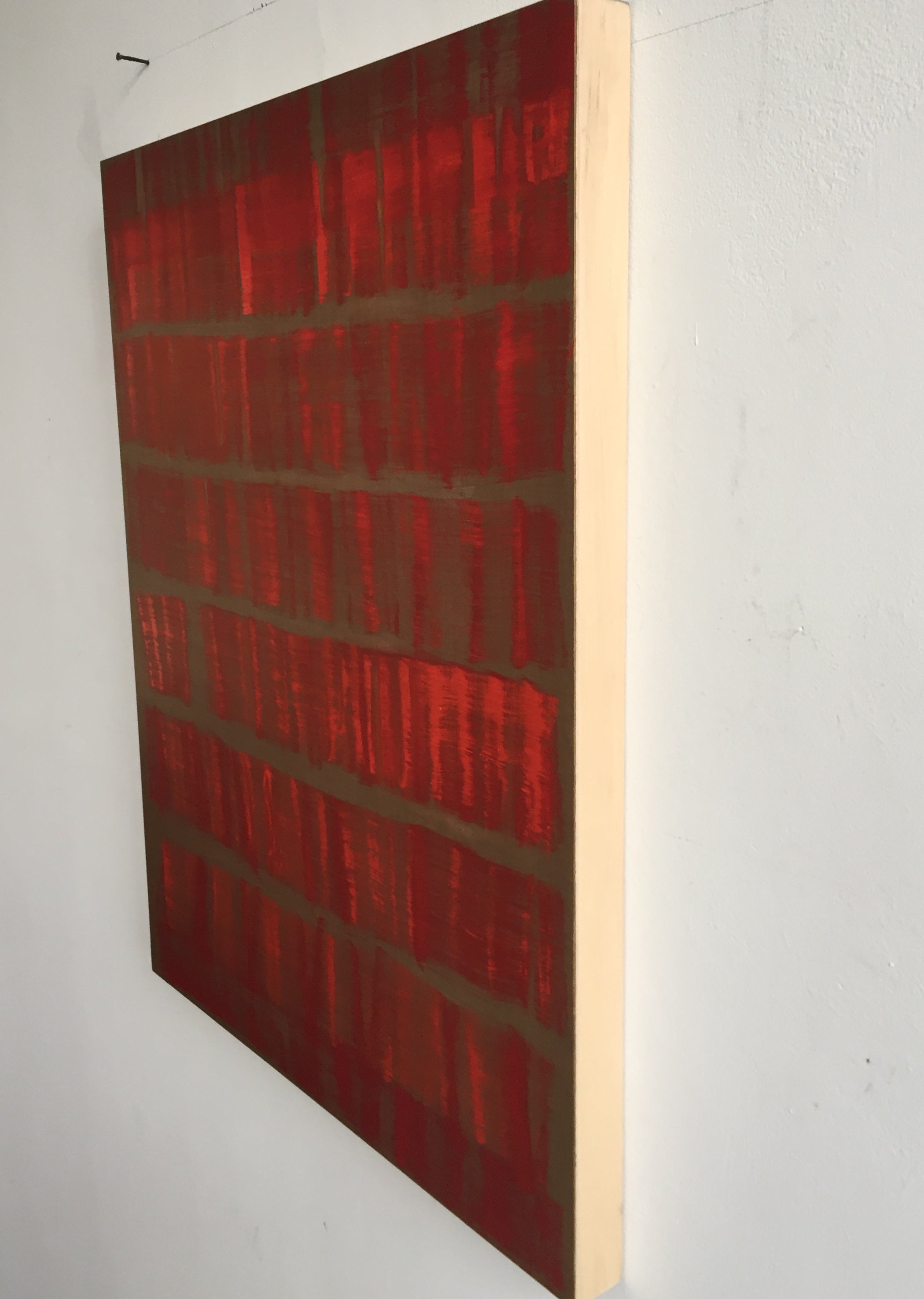 A painting of red and brown squares on a brown background.