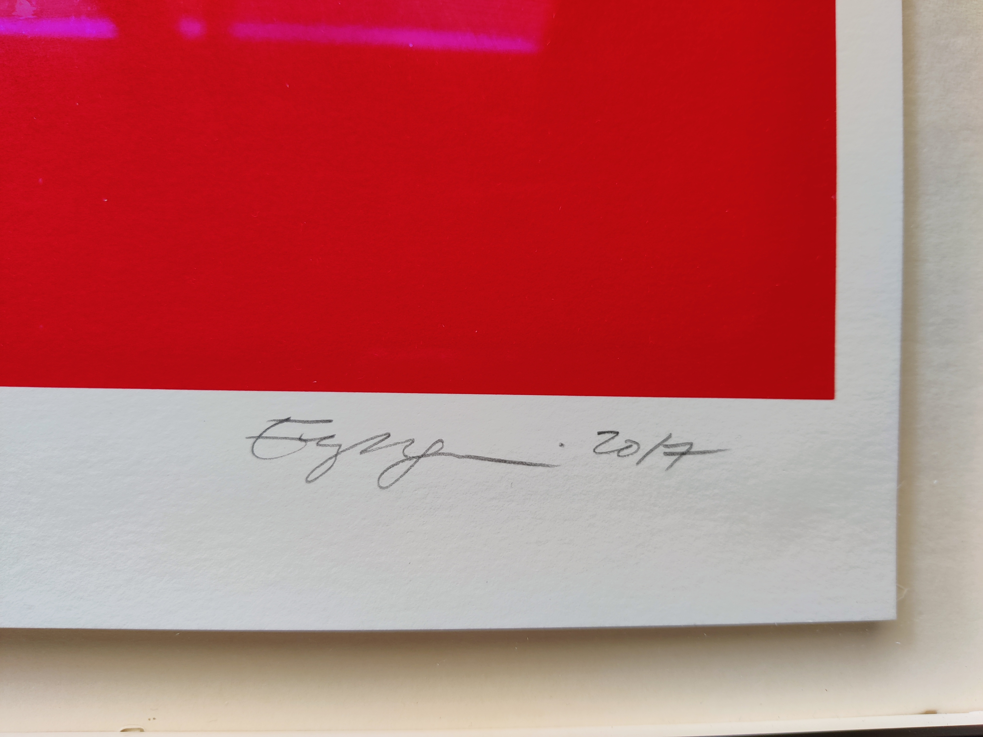 A red and white poster with a toothbrush sticking out of it.
