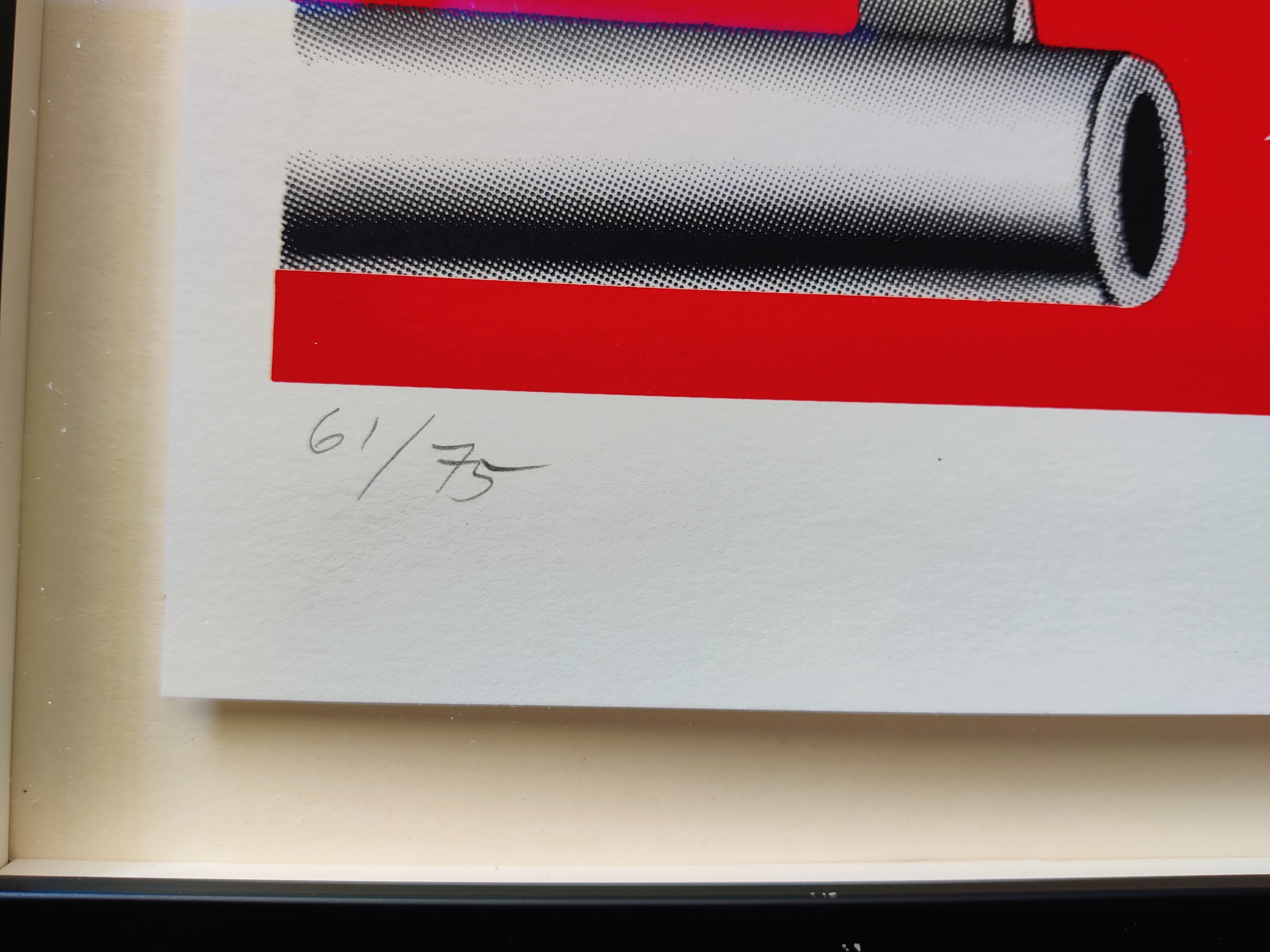 A red and white poster with a toothbrush sticking out of it.