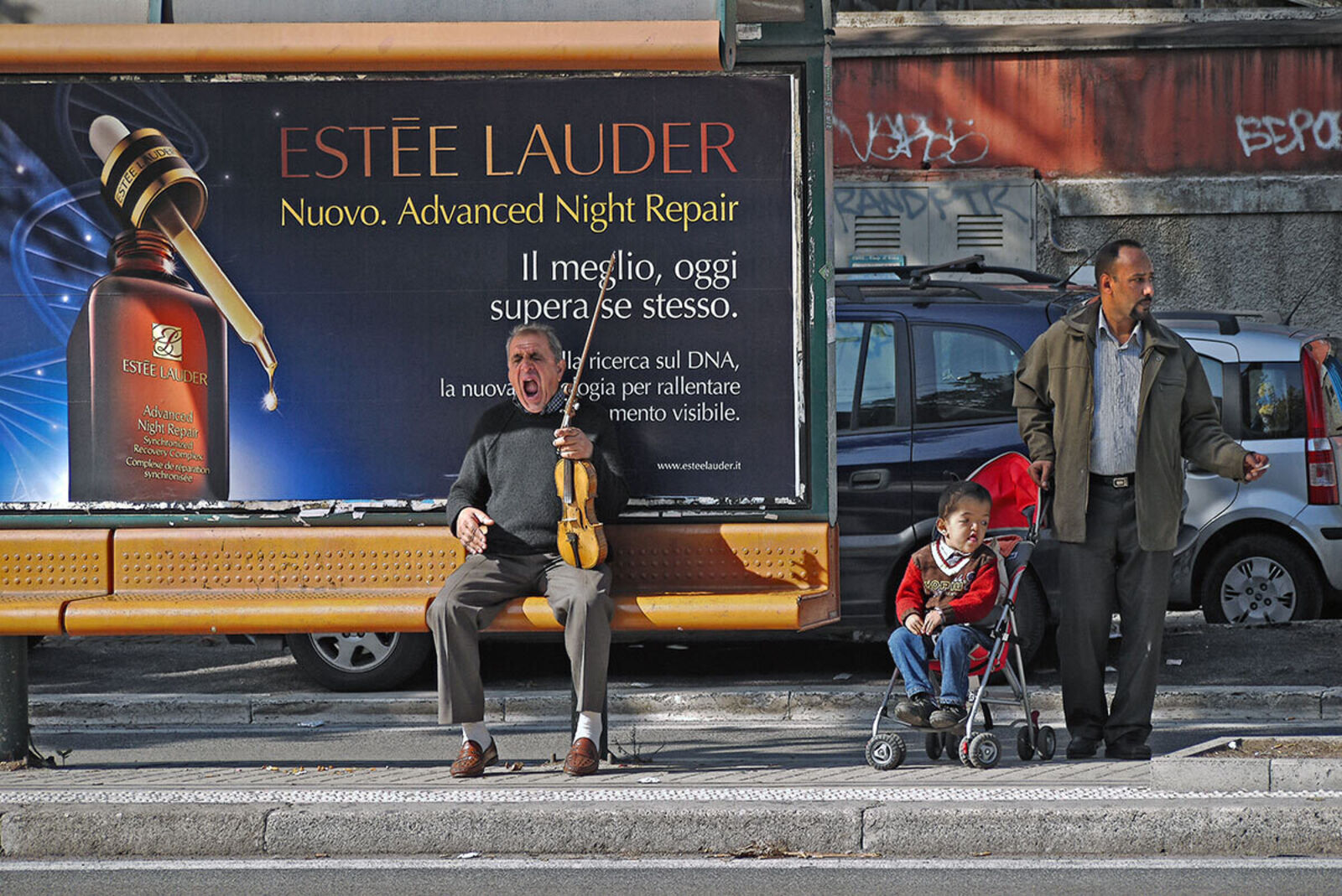 Waiting for Godot - Rome, Bus Stop with Violinist and Estée Lauder Ad by Enzo Ragazzini, 2013