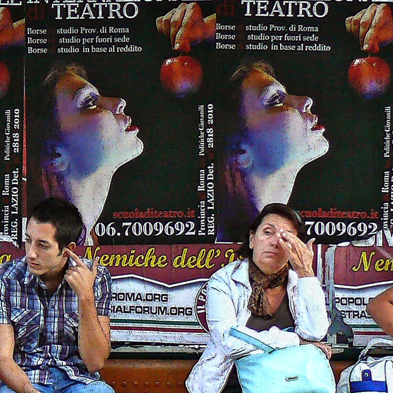 A group of people sitting on a bench in front of a bus stop.