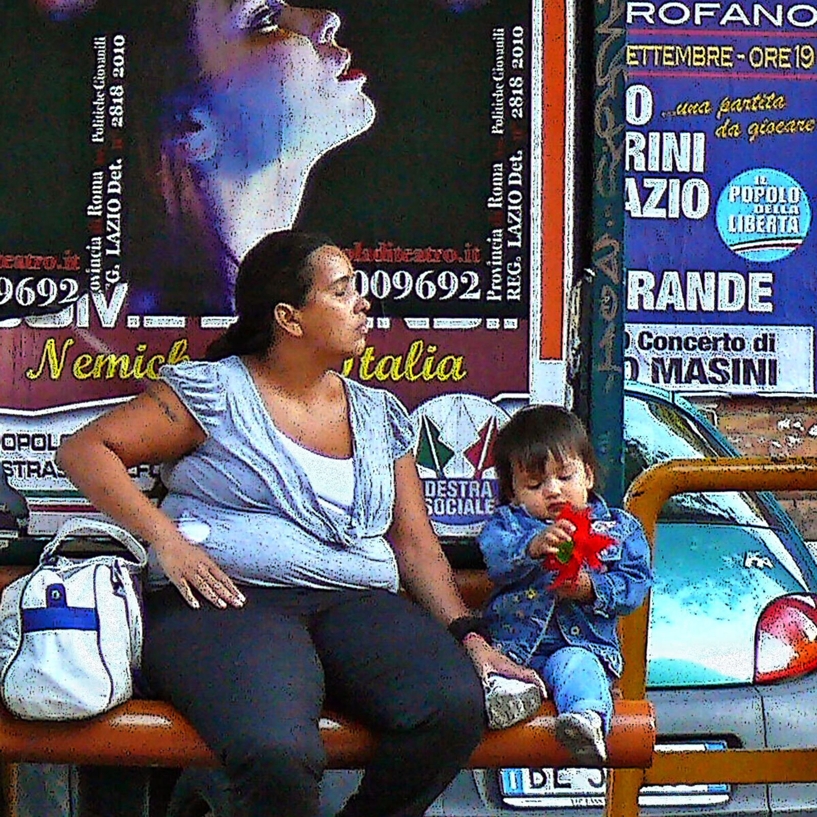 A group of people sitting on a bench in front of a bus stop.