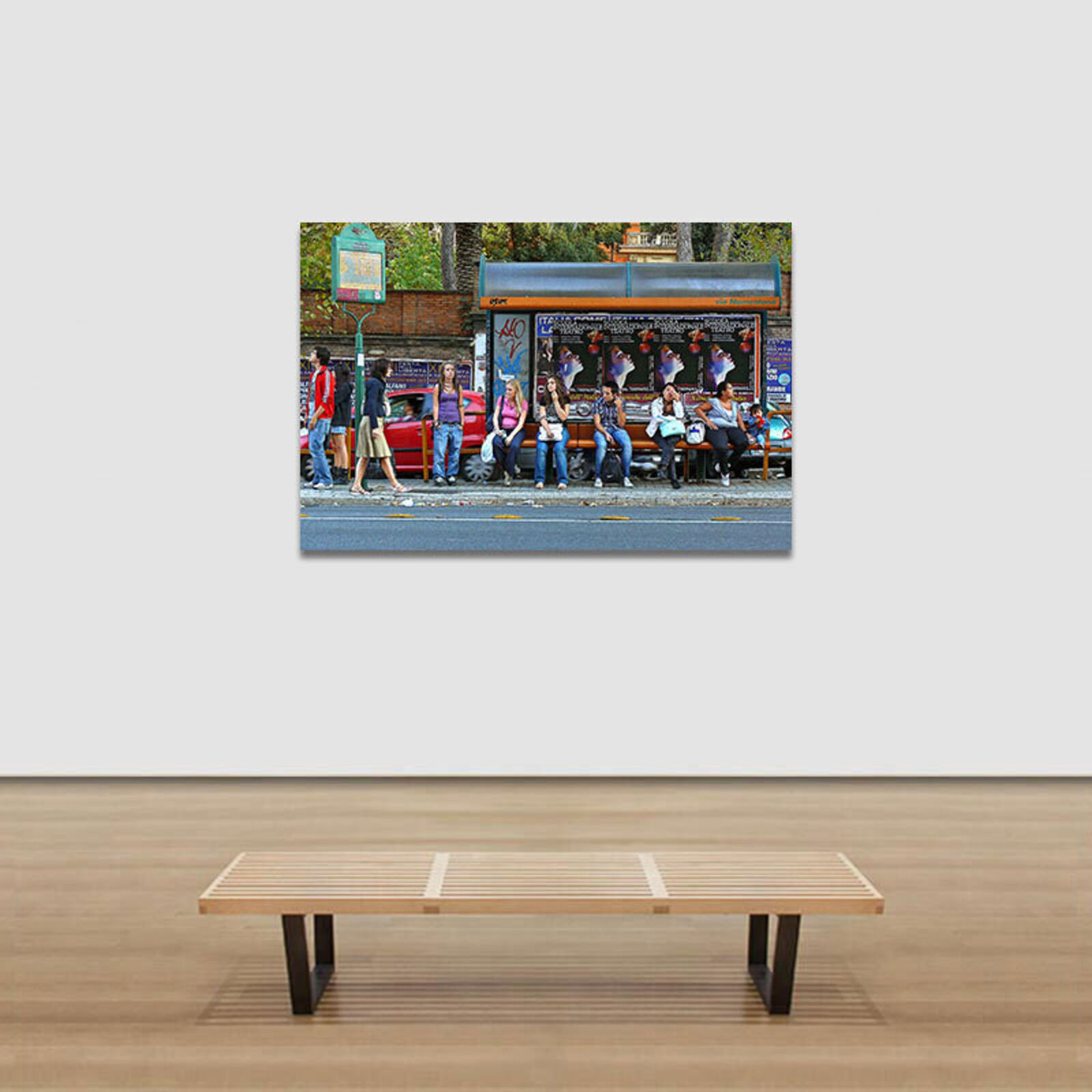 A group of people sitting on a bench in front of a bus stop.