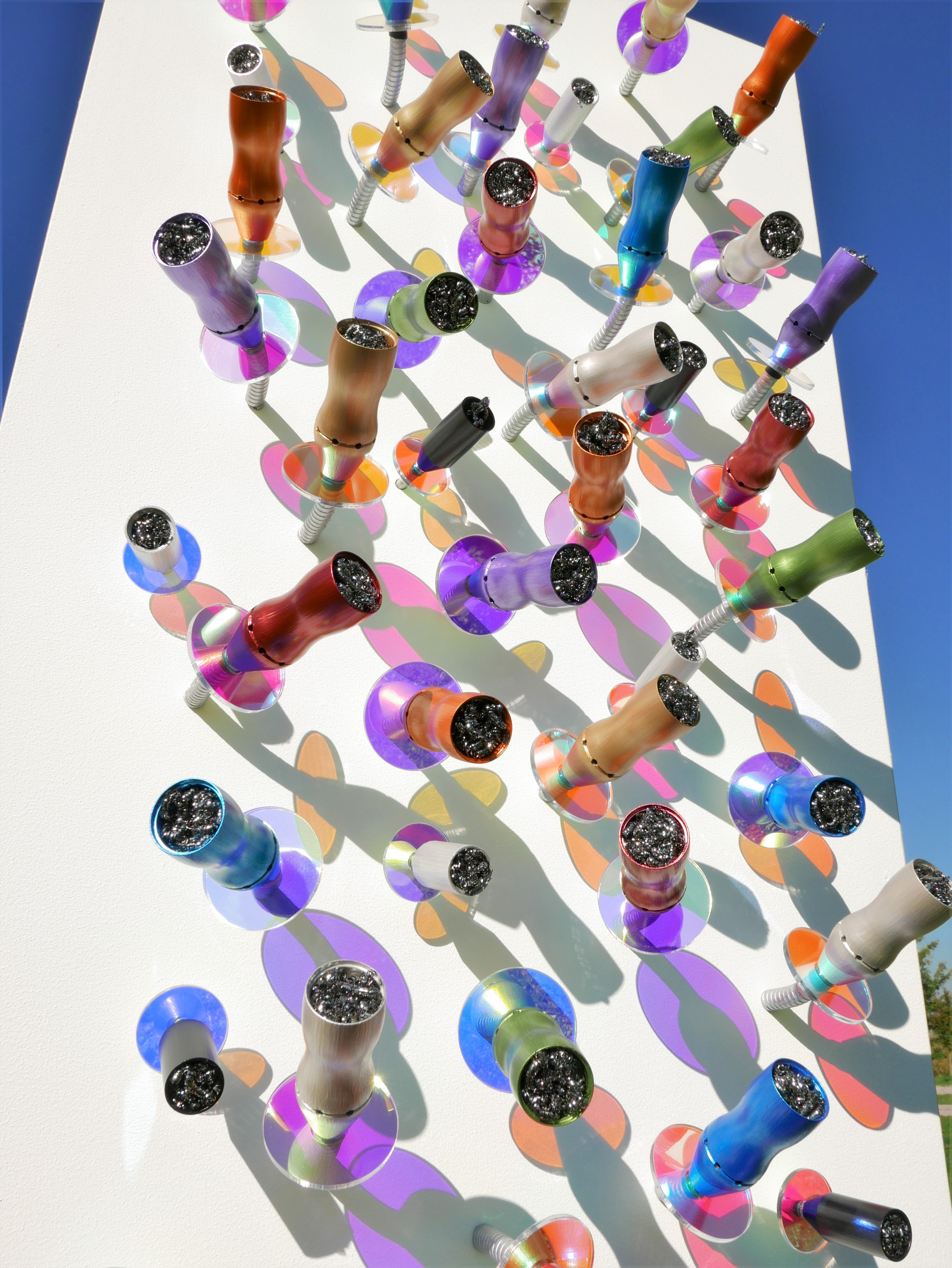 A group of colorful glass beads on a white surface.