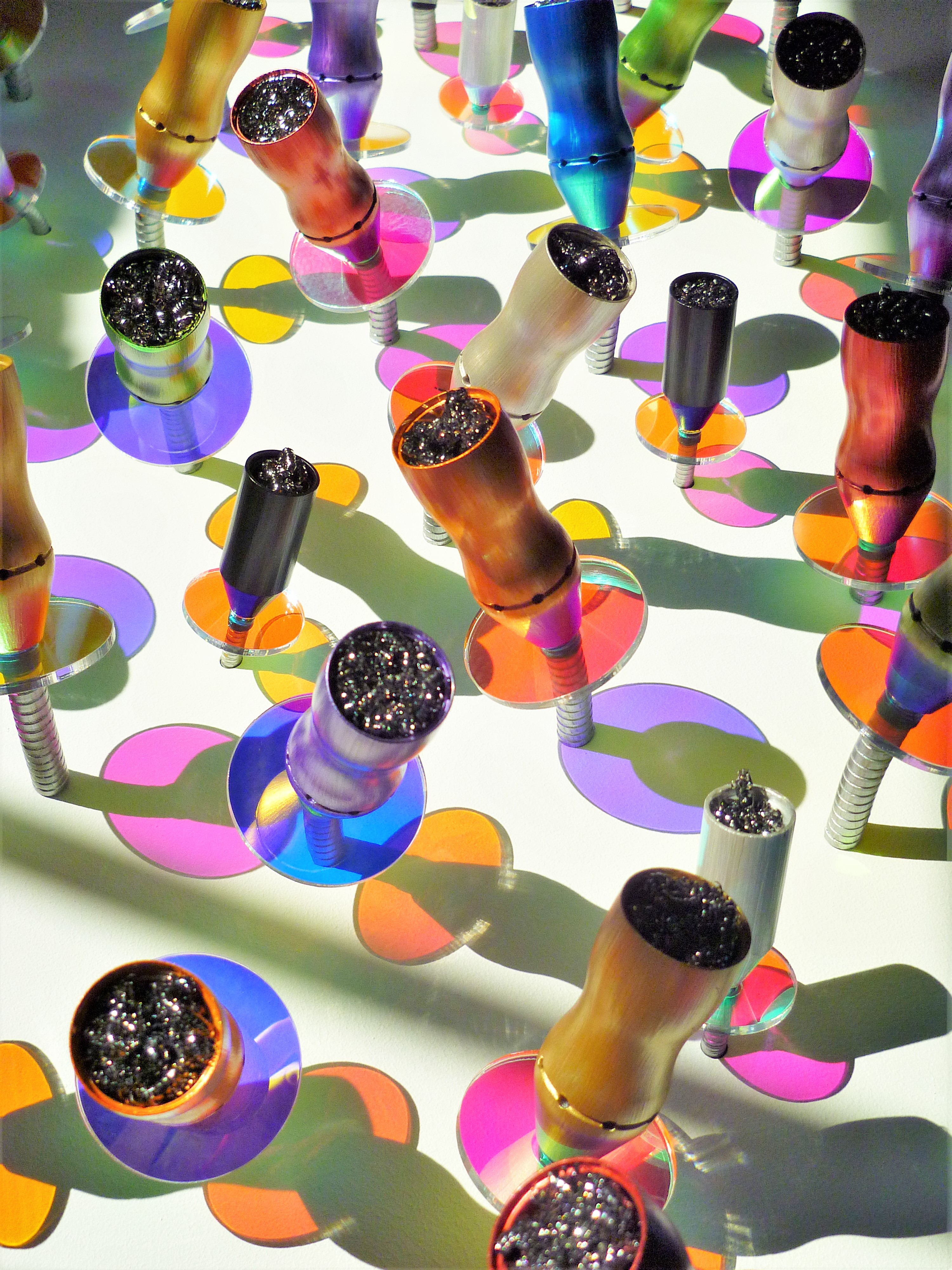 A group of colorful glass beads on a white surface.