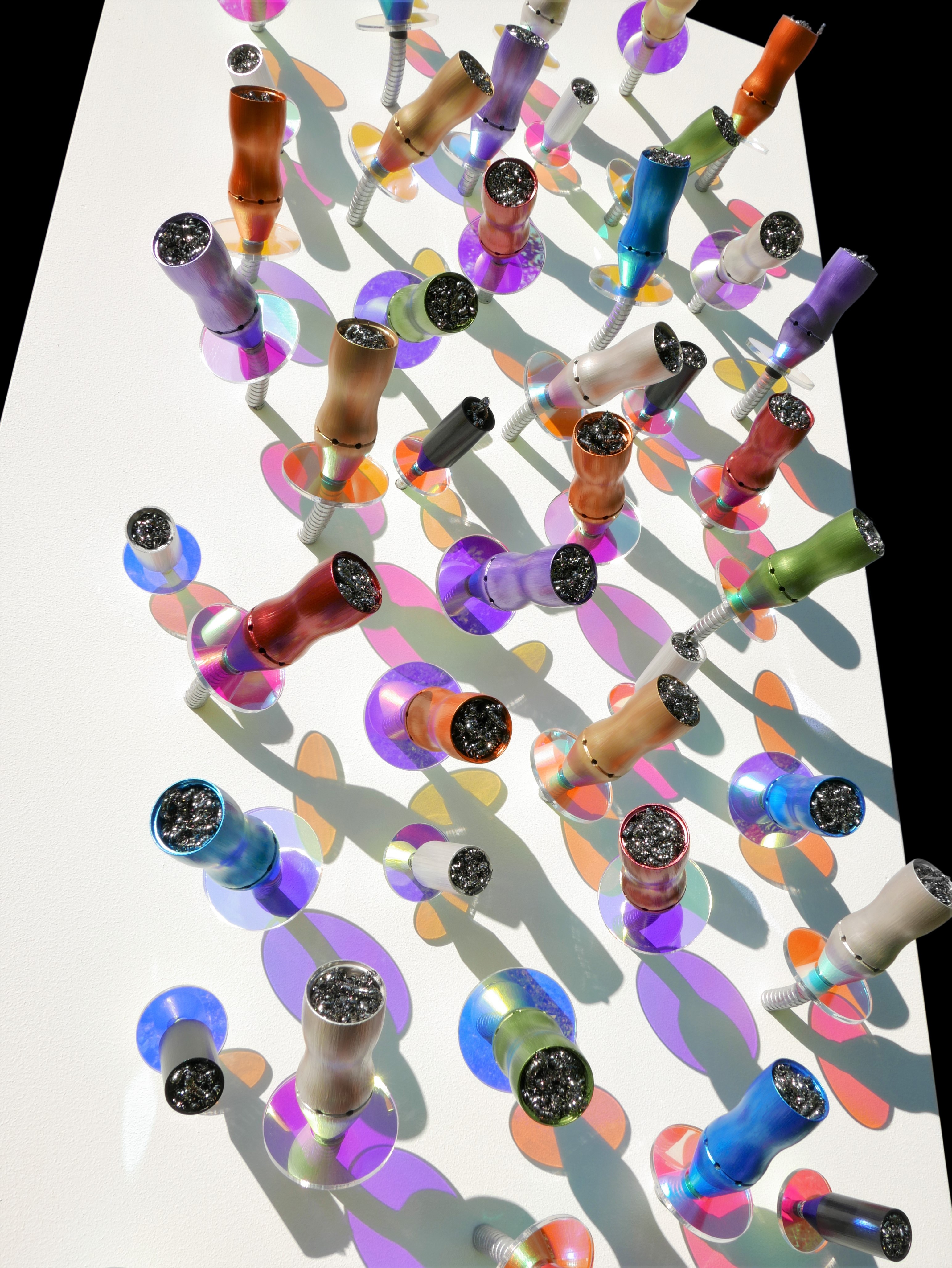 A group of colorful glass beads on a white surface.