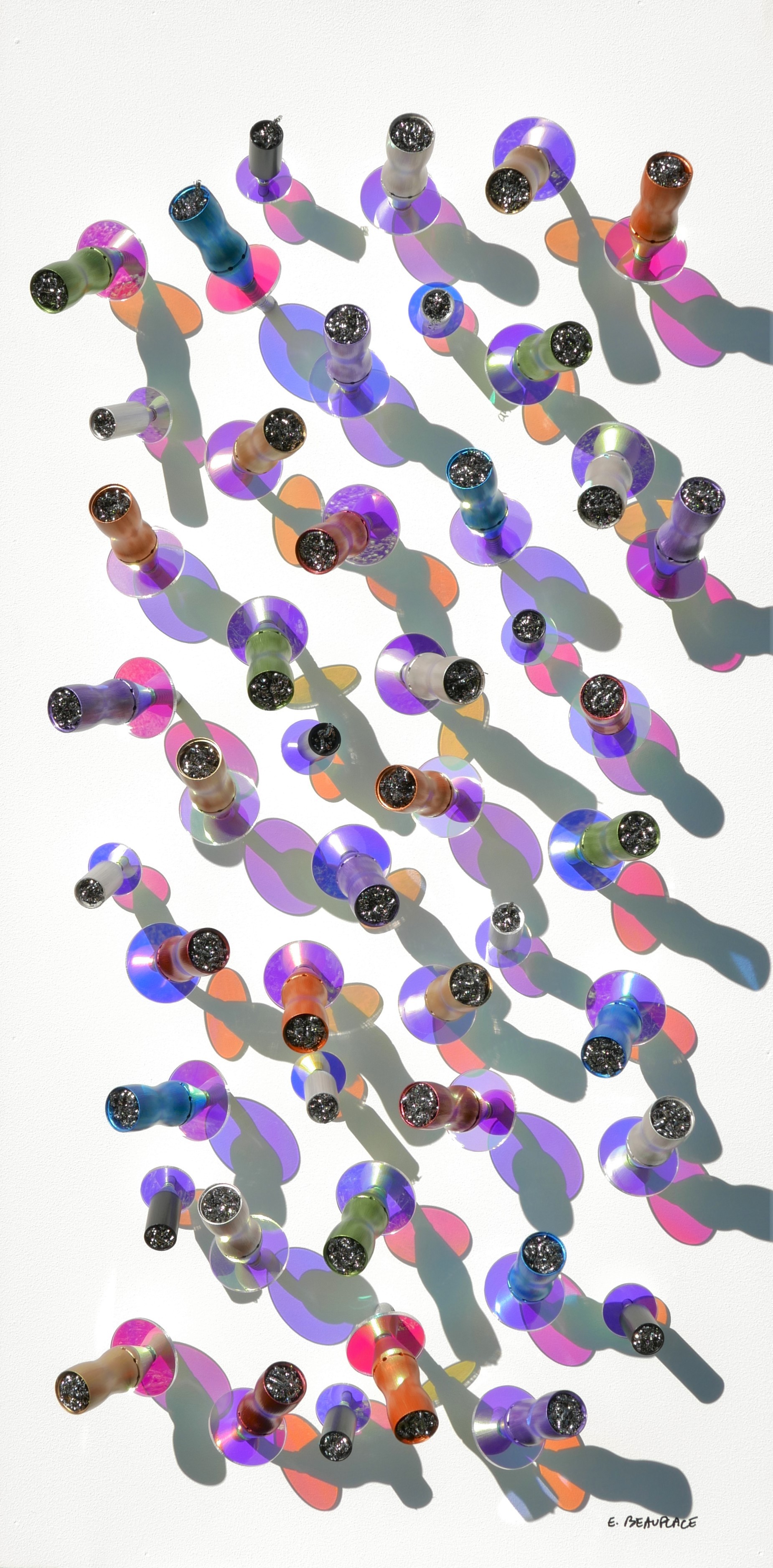 A group of colorful glass beads on a white surface.