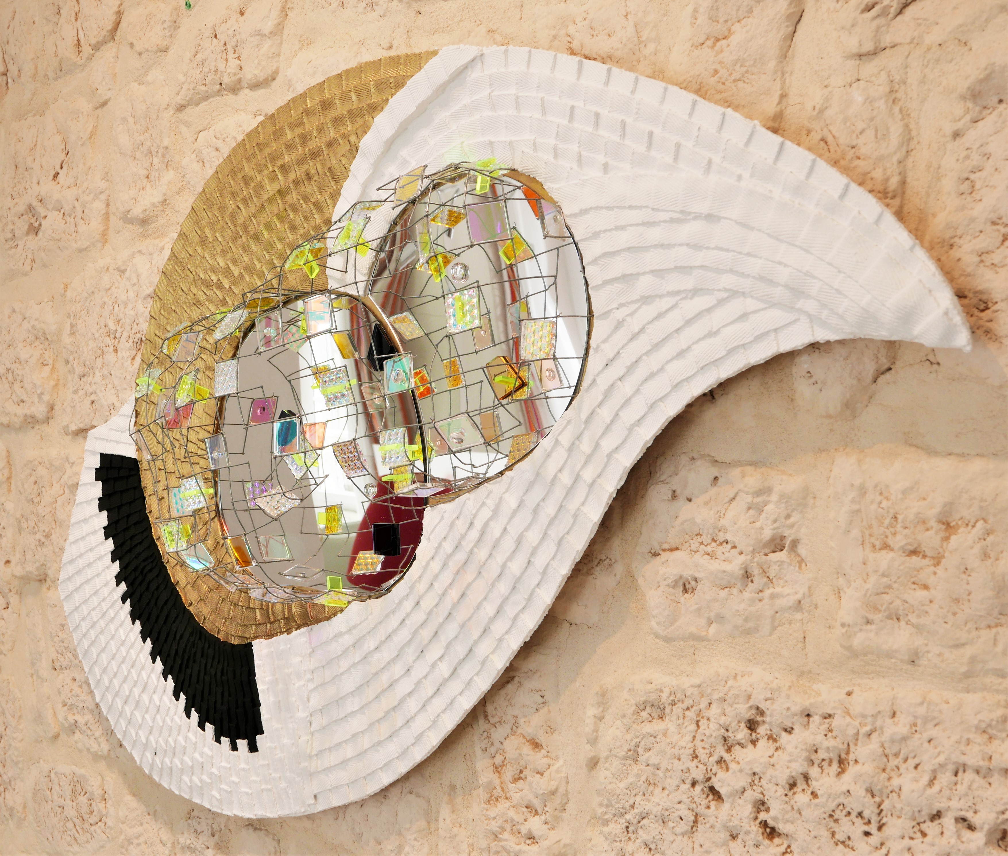 A white hat with a mirror ball on top of it.