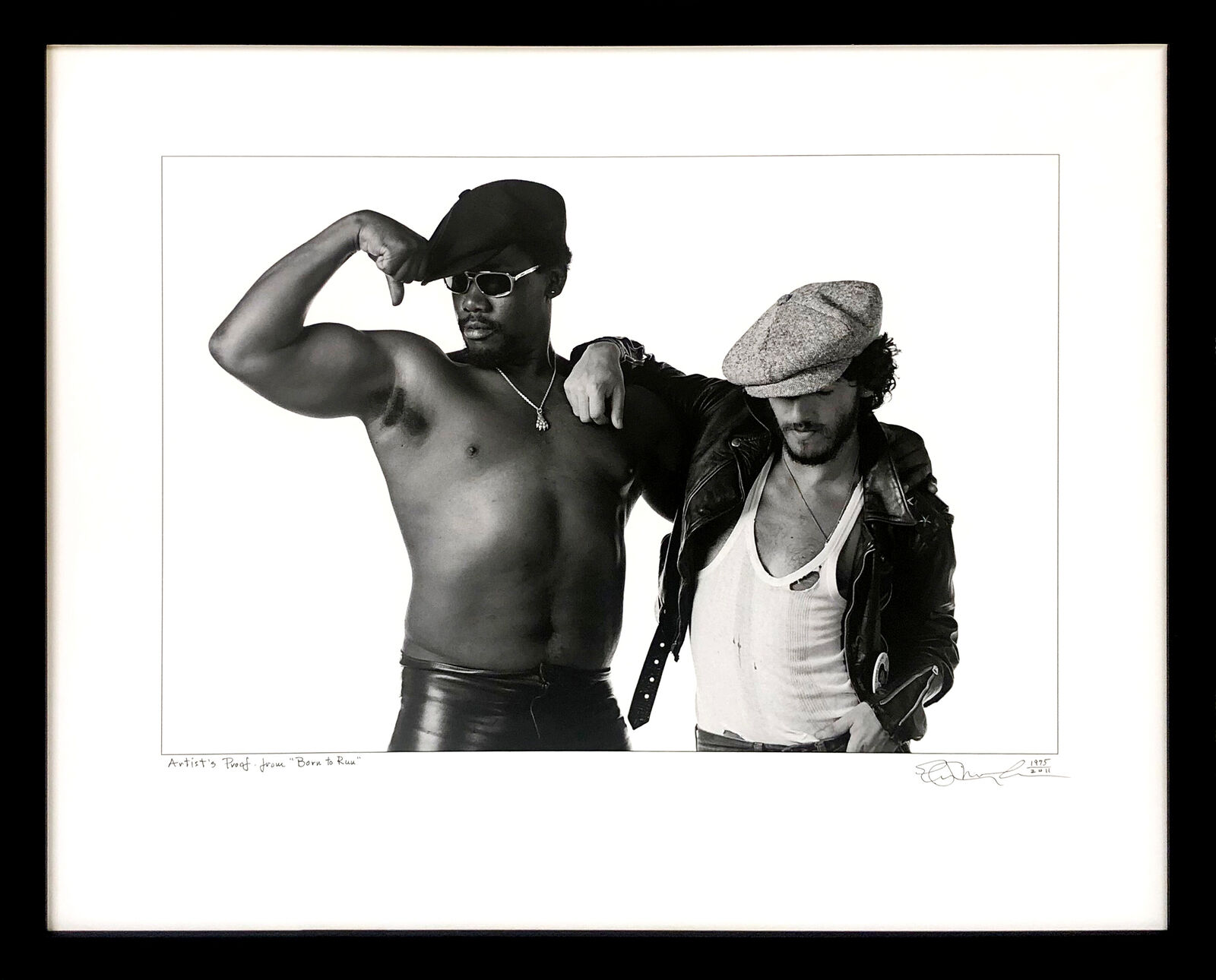 A black and white photo of two men posing for a picture.