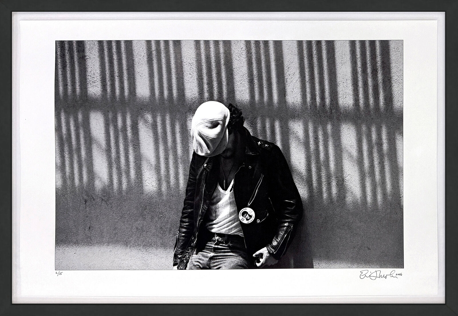 A black and white photo of a man wearing a mask.