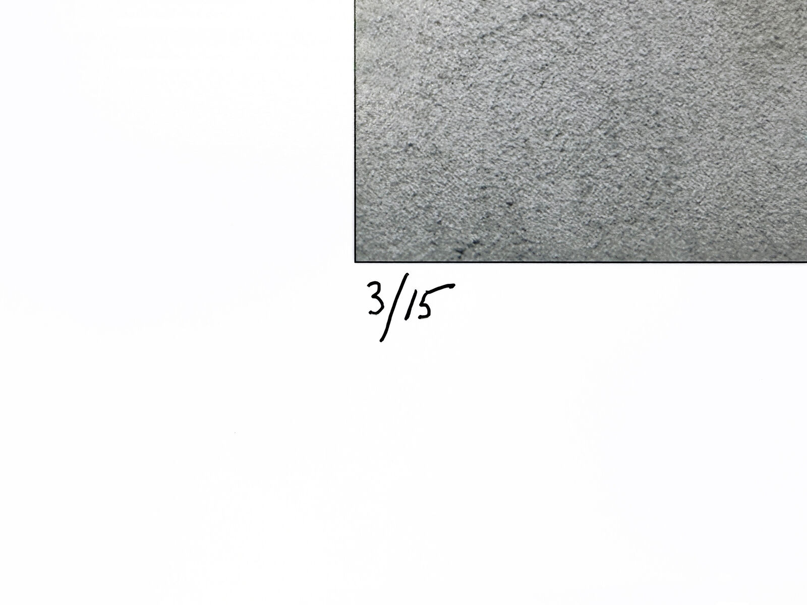 A black and white photo of a man standing in front of a wall.