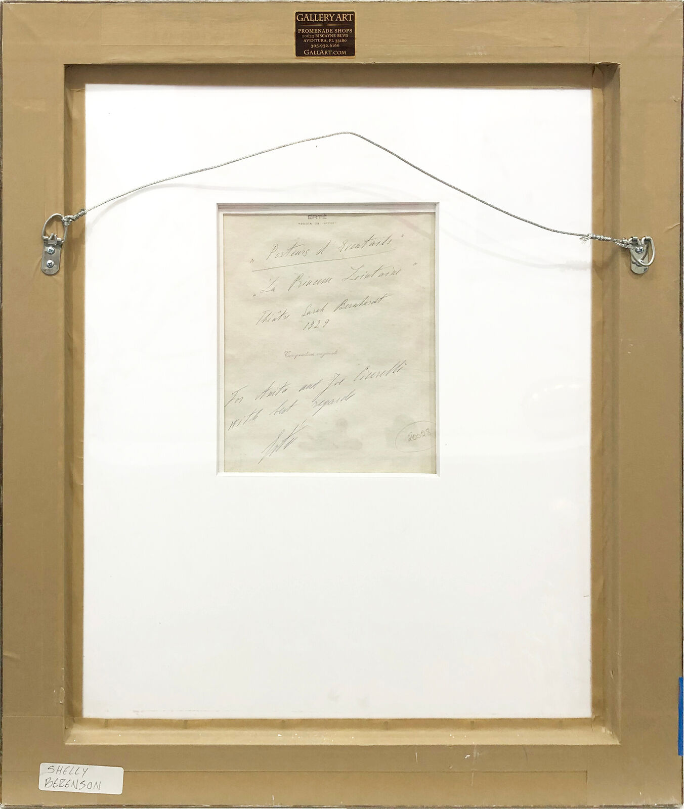 A painting of a woman holding an umbrella in a gold frame.