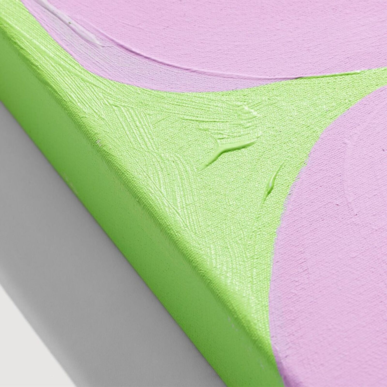 A painting on a wall with a pink and green background.