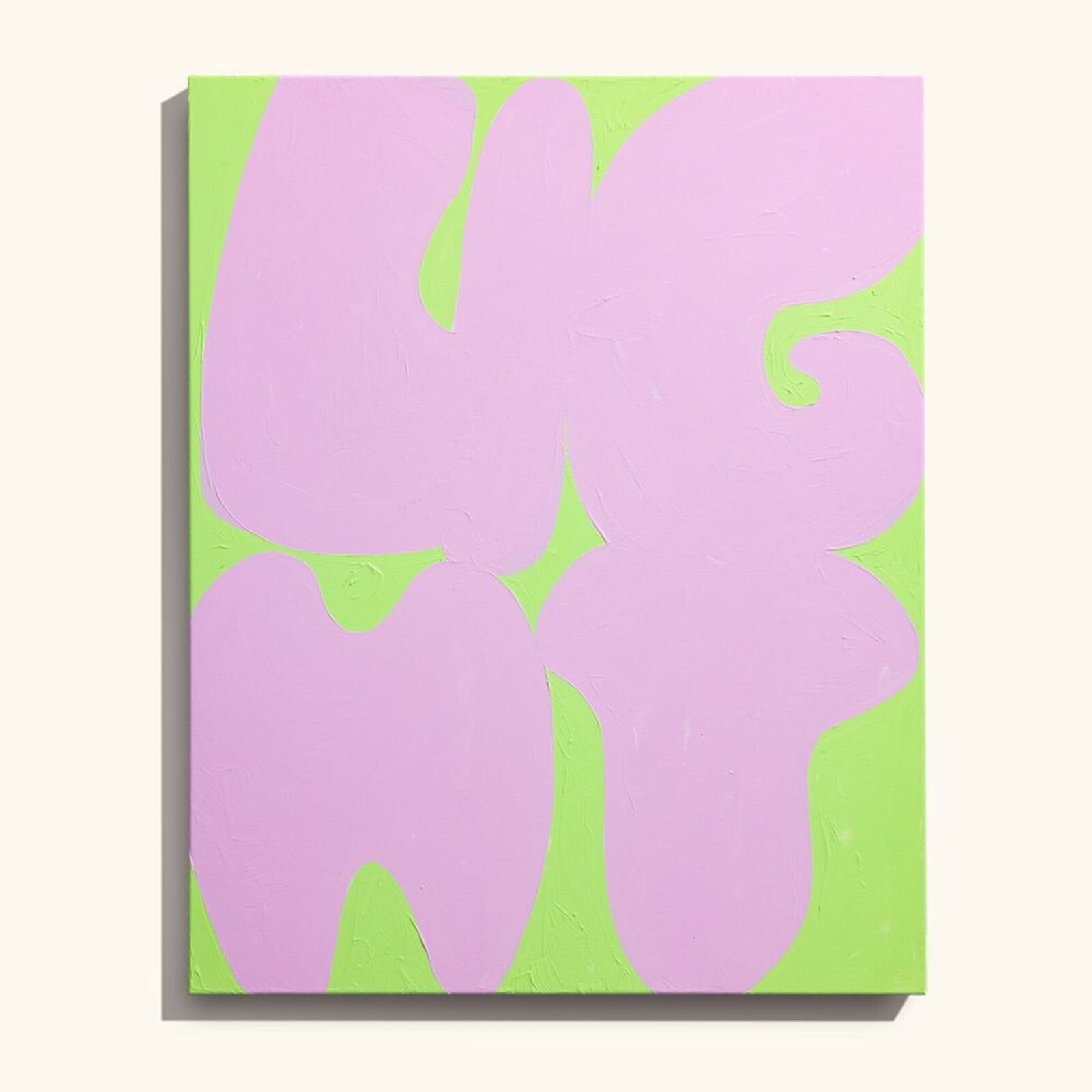 A painting on a wall with a pink and green background.