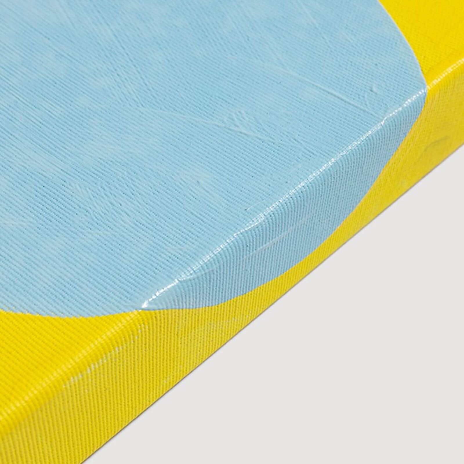 A blue and yellow painting on a white wall.