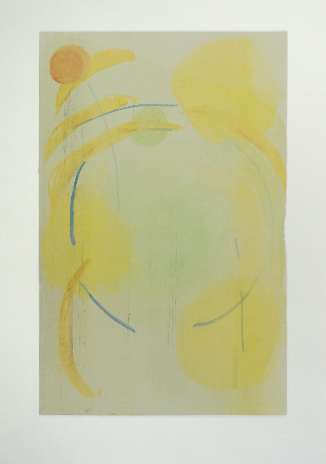 A painting on a white wall with yellow and green paint.