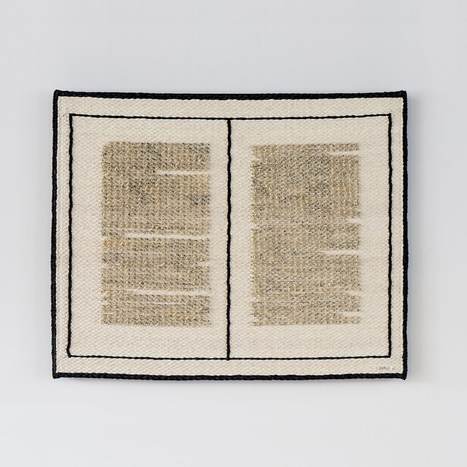 A minimalist textile artwork resembling an open book with woven text patterns.