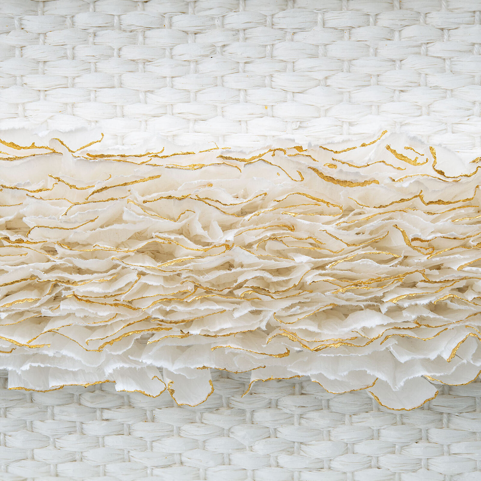 A minimalist textile piece featuring a woven white background with horizontal strips of textured, golden-brown fibers.