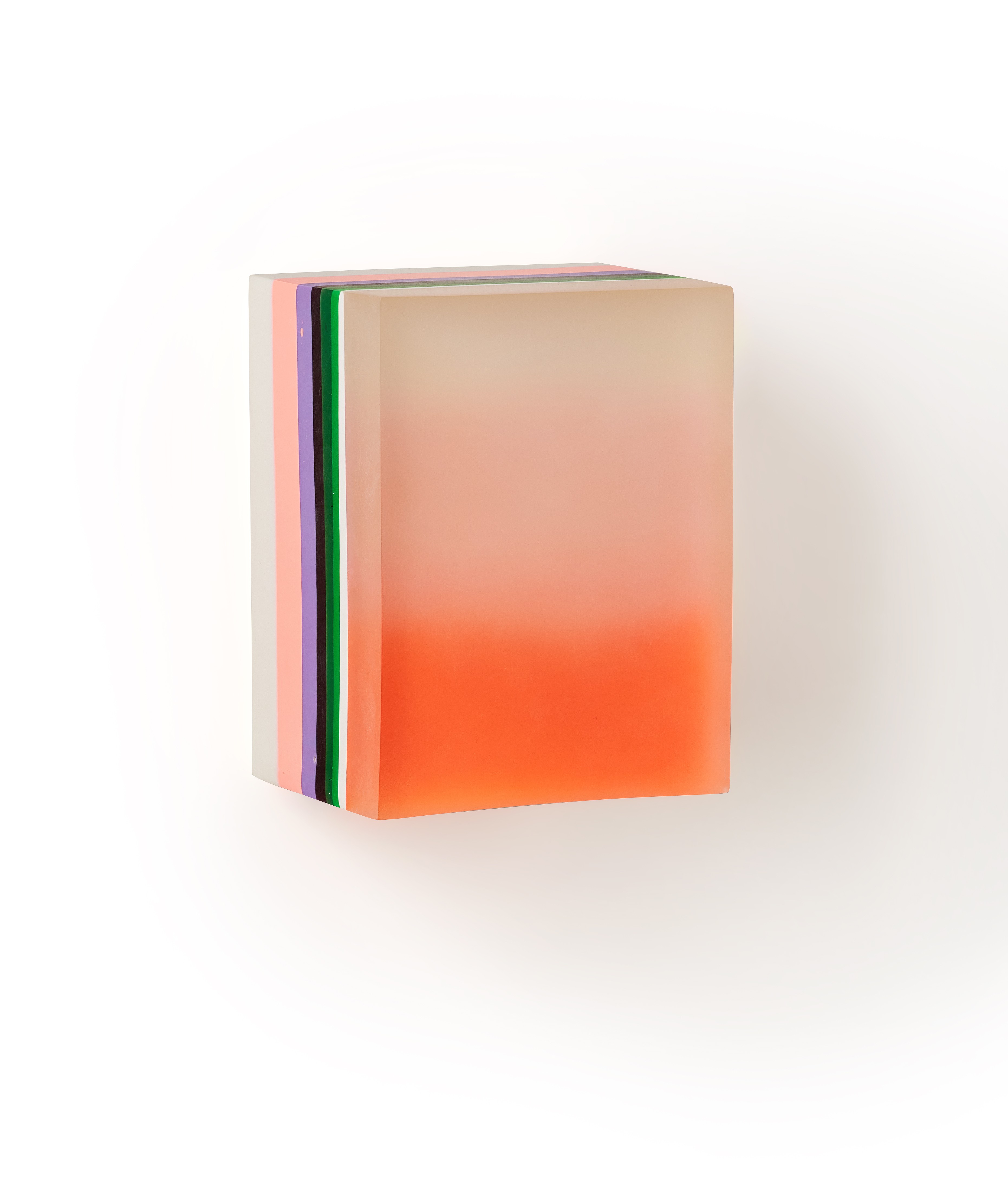 A stack of books sitting on top of each other on a white surface.