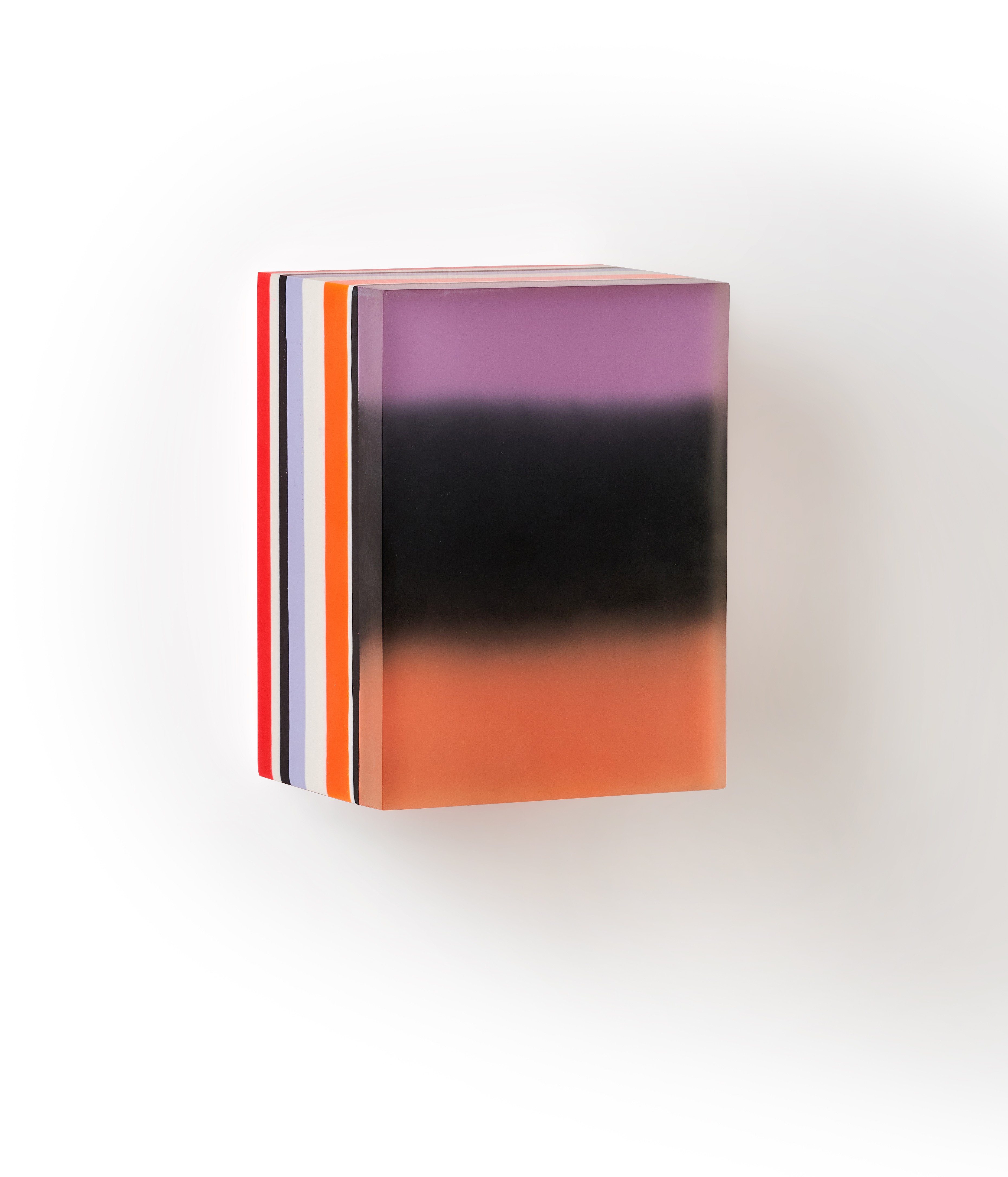 A colorful box with a black and orange stripe on it.