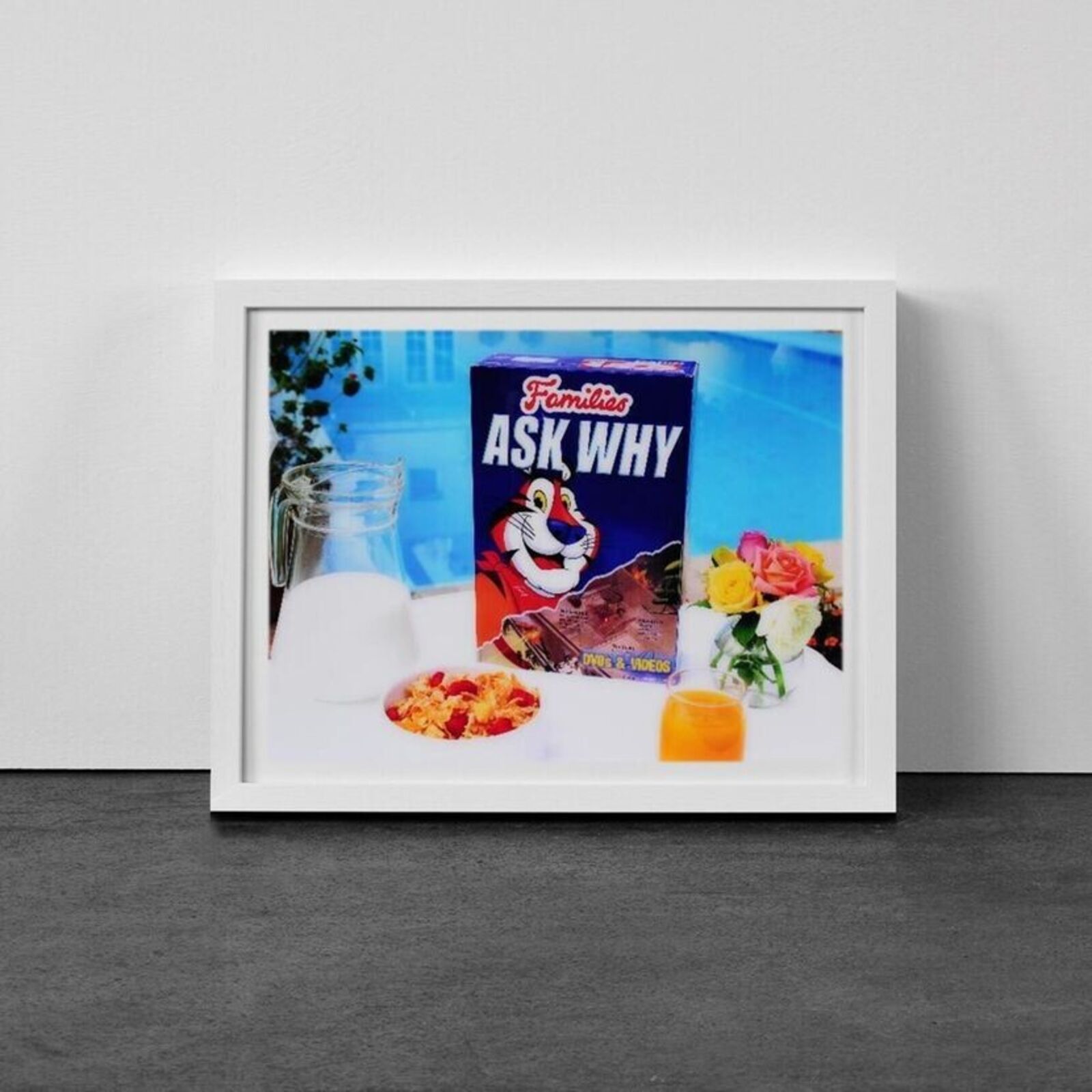 A picture of a box of cereal and a glass of milk.