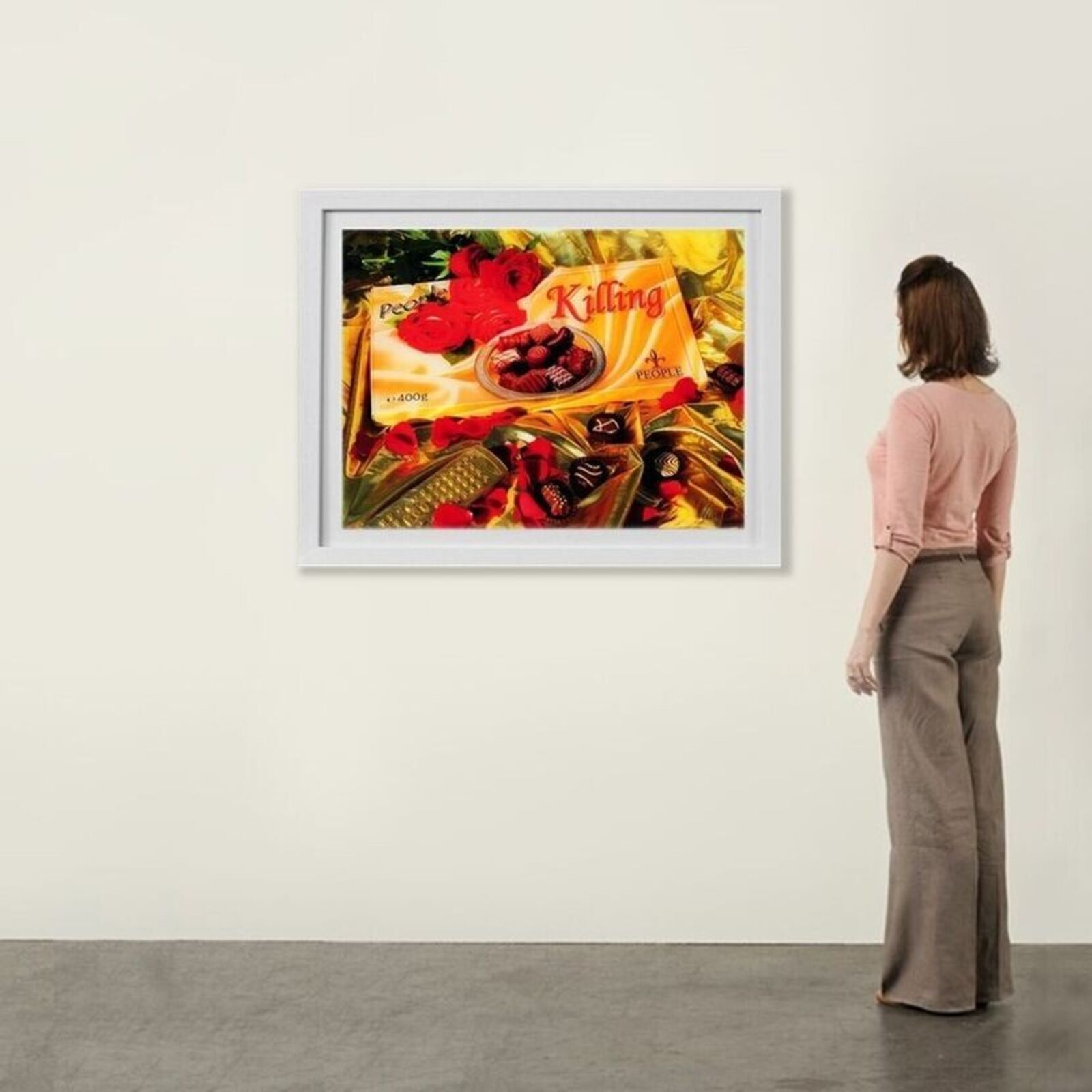 A woman standing in front of a painting on a wall.