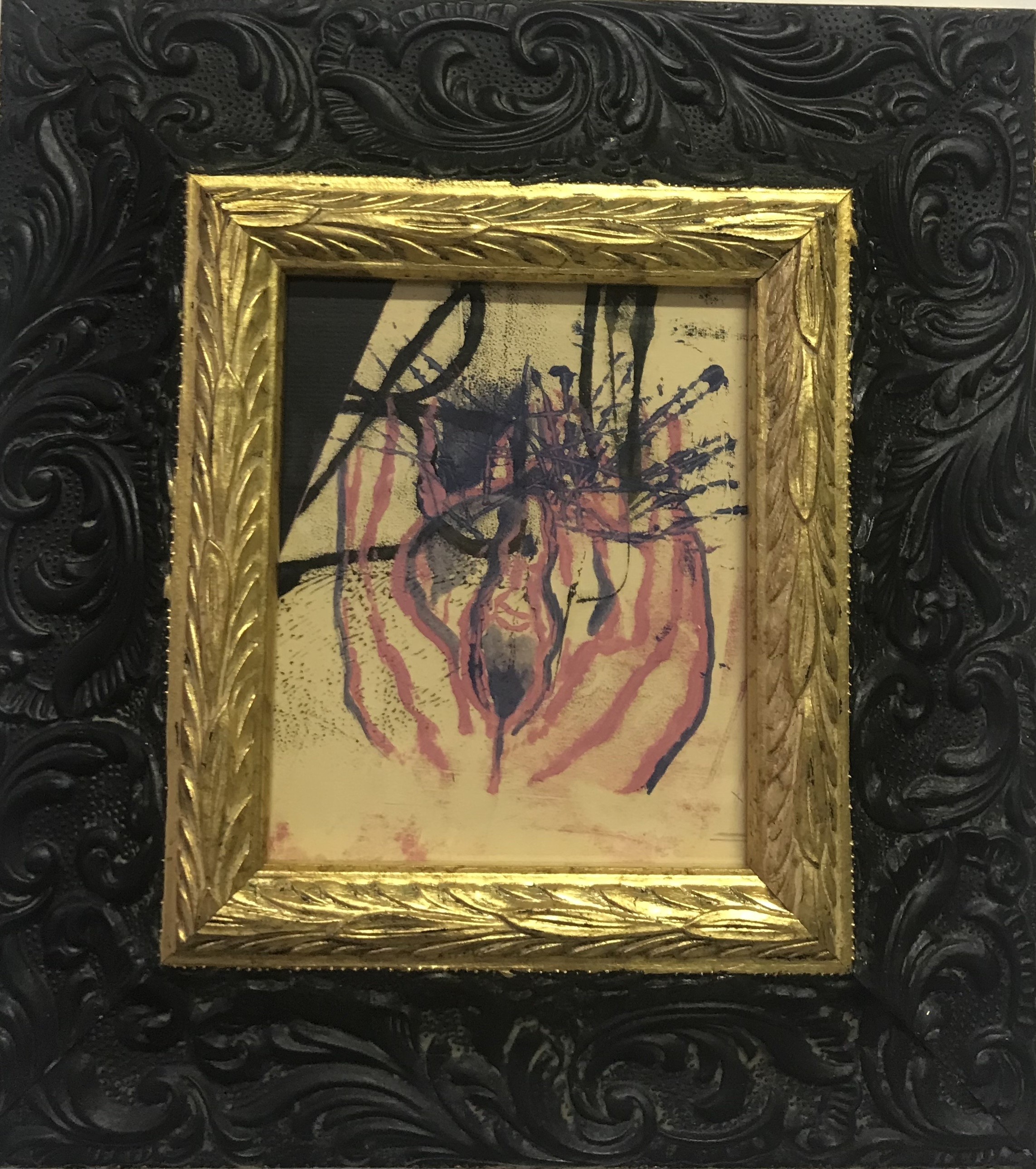 A painting in a gold frame on a black wall.