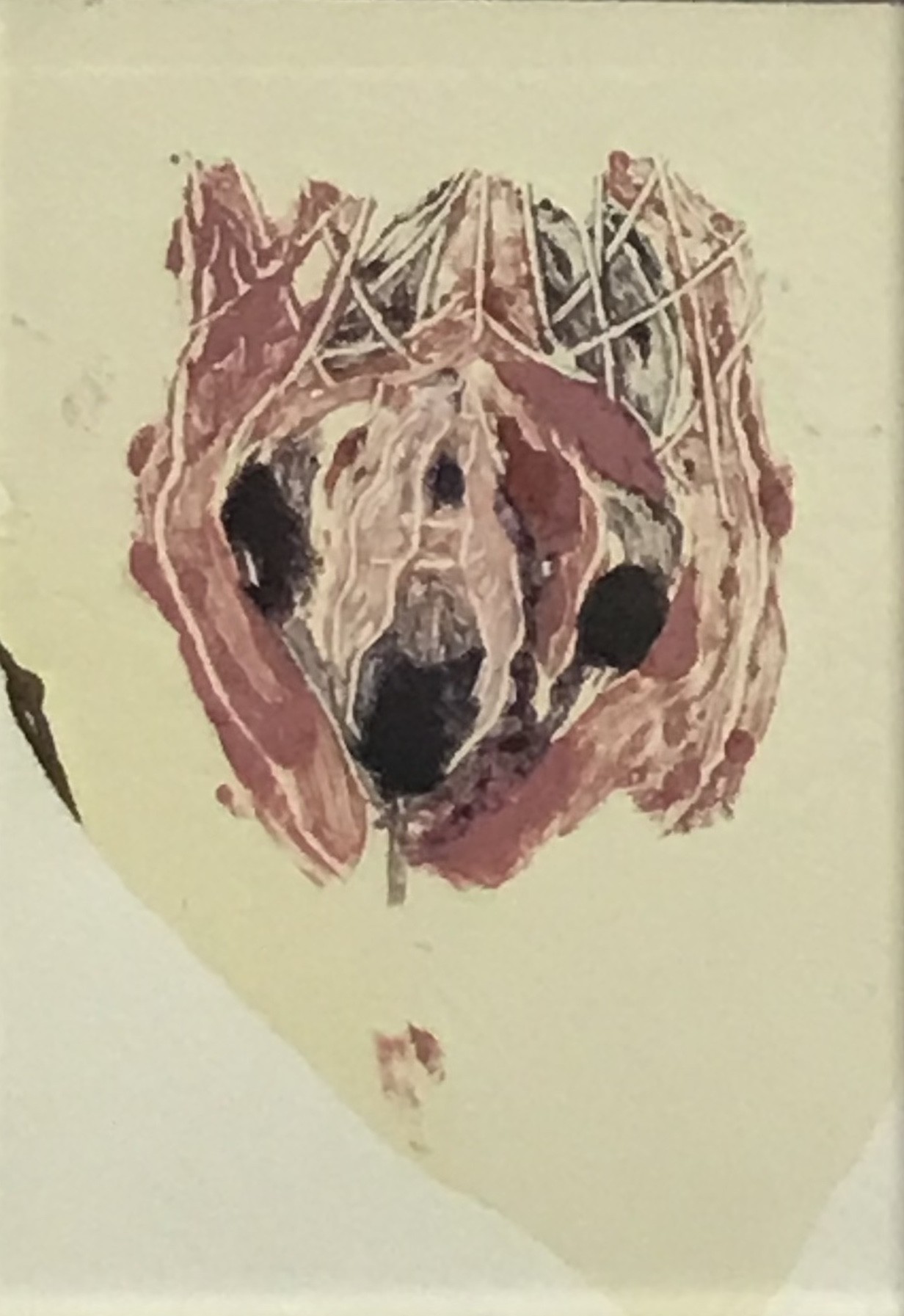 A picture of a dog's head in a silver frame.
