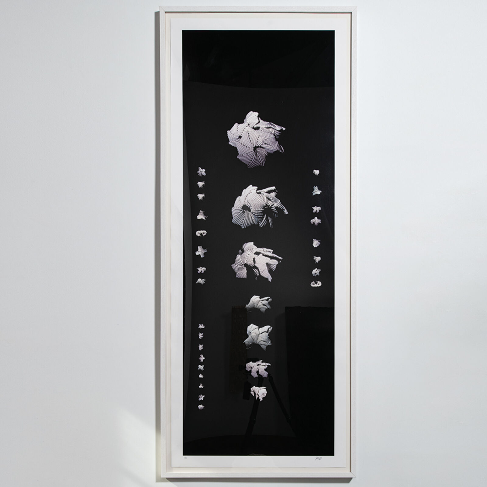 A black and white picture hanging on a wall.