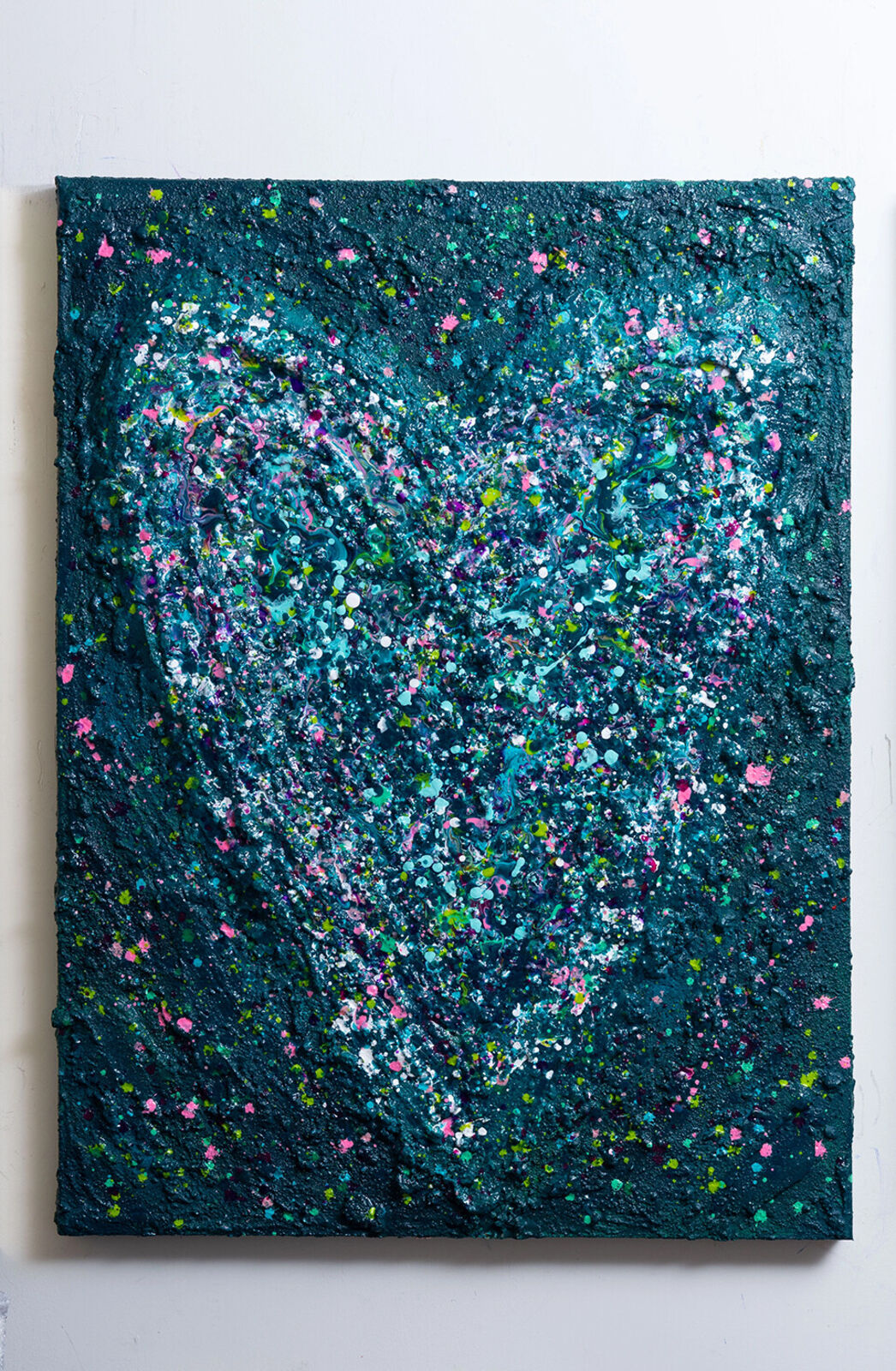 A painting of a heart made out of paint splatters on a black background.