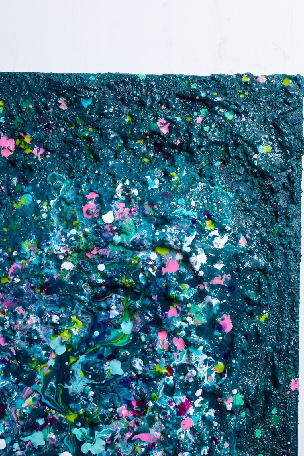 A painting of a heart made out of paint splatters on a black background.