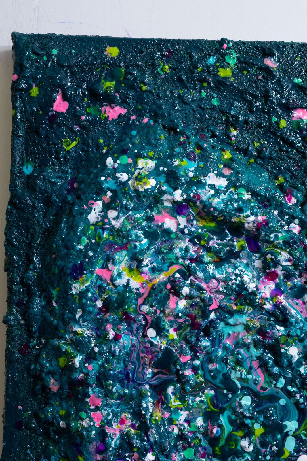 A painting of a heart made out of paint splatters on a black background.