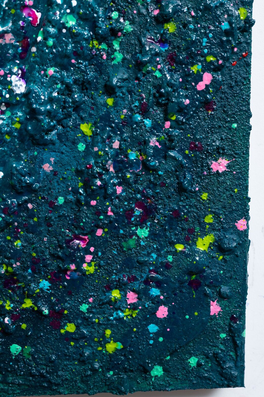 A painting of a heart made out of paint splatters on a black background.